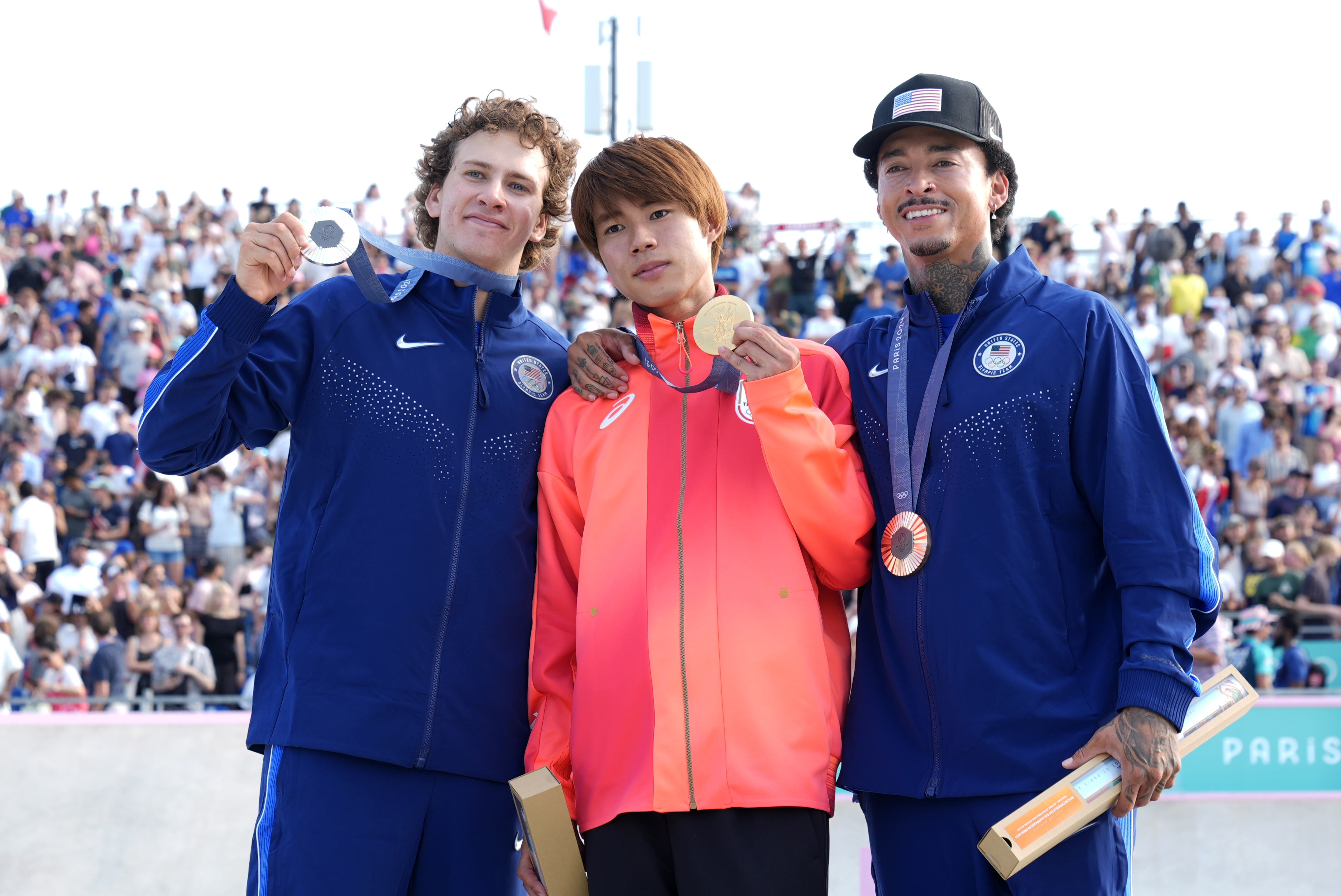 Gold medalist Yuto Horigome, of Japan, center, poses with silver medalist Jagger Eaton, of the United States, left, and bronze medalist Nyjah Huston, of the United States, after the men's skateboard street final at the 2024 Summer Olympics, Monday, July 29, 2024, in Paris, France. (AP Photo/Frank Franklin II)