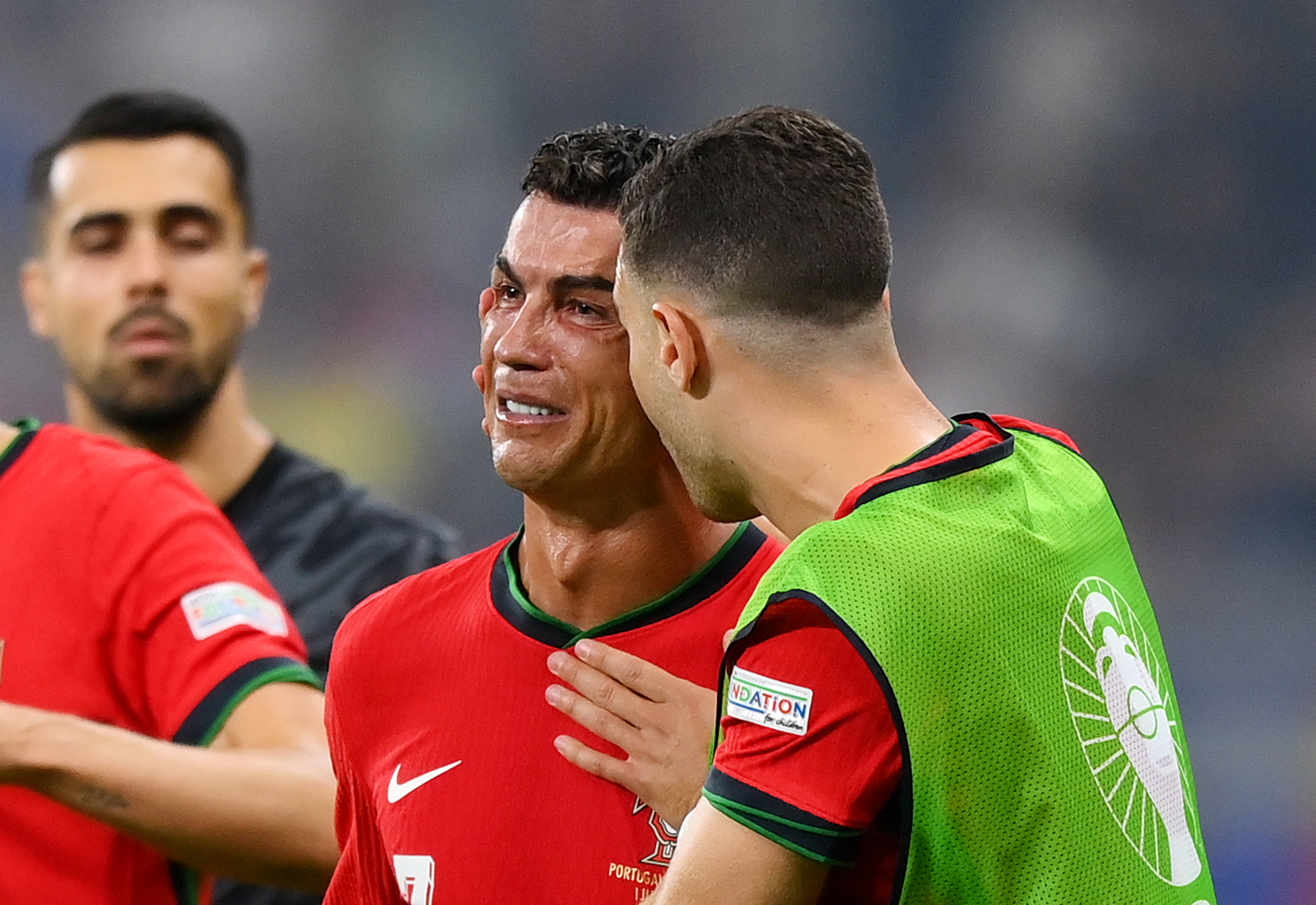 FRANKFURT AM MAIN, GERMANY - JULY 01: Cristiano Ronaldo of Portugal looks dejected as he is consoled by teammates ahead of the second half of extra-time during the UEFA EURO 2024 round of 16 match between Portugal and Slovenia at Frankfurt Arena on July 01, 2024 in Frankfurt am Main, Germany. (Photo by Justin Setterfield/Getty Images)