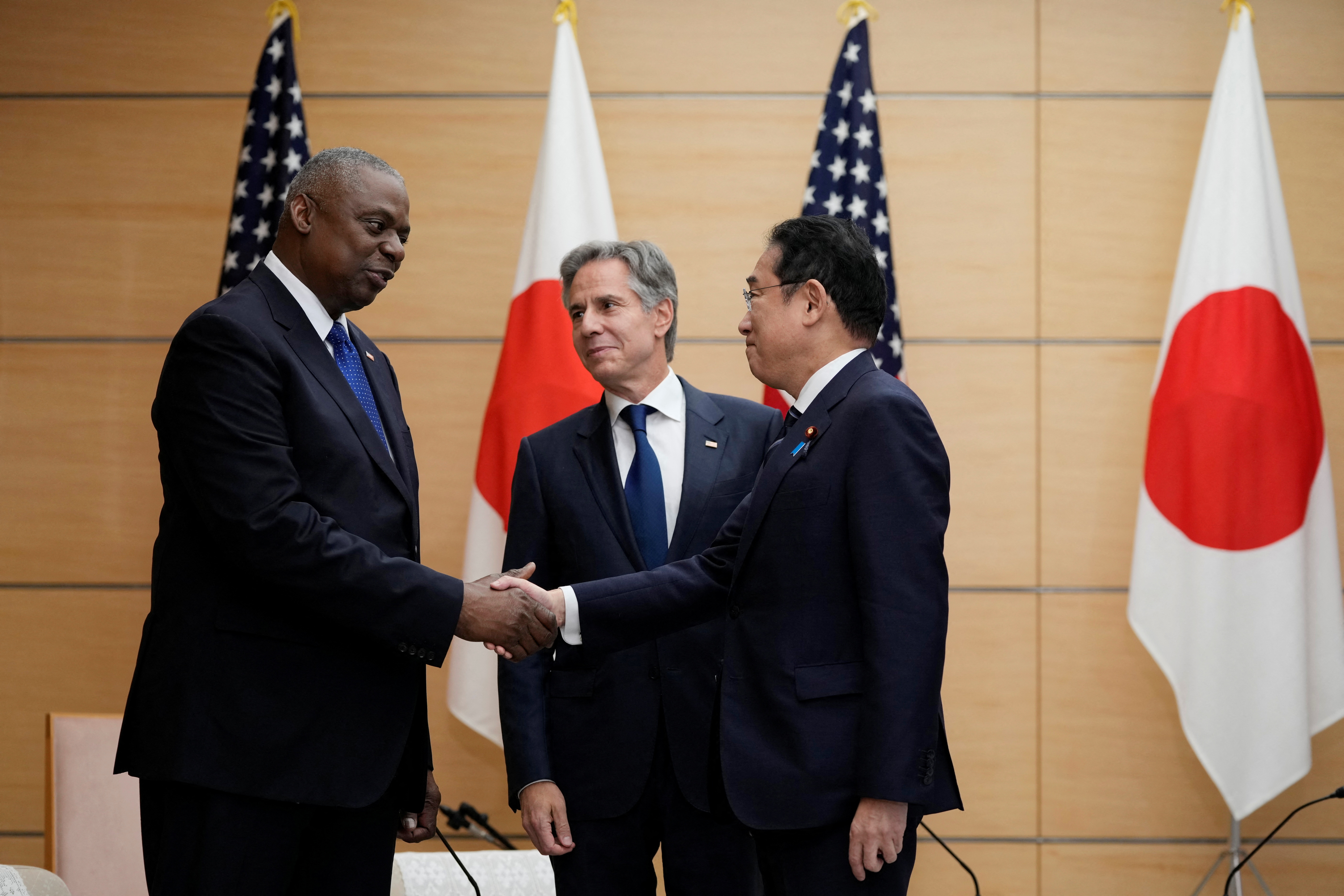 U.S. Secretary of State Antony Blinken looks at Japanese Prime Minister Fumio Kishida shake hands with U.S. Defense Secretary Lloyd Austin as they meet at the prime minister's office in Tokyo, Japan, July 29, 2024. Shuji Kajiyama/Pool via REUTERS