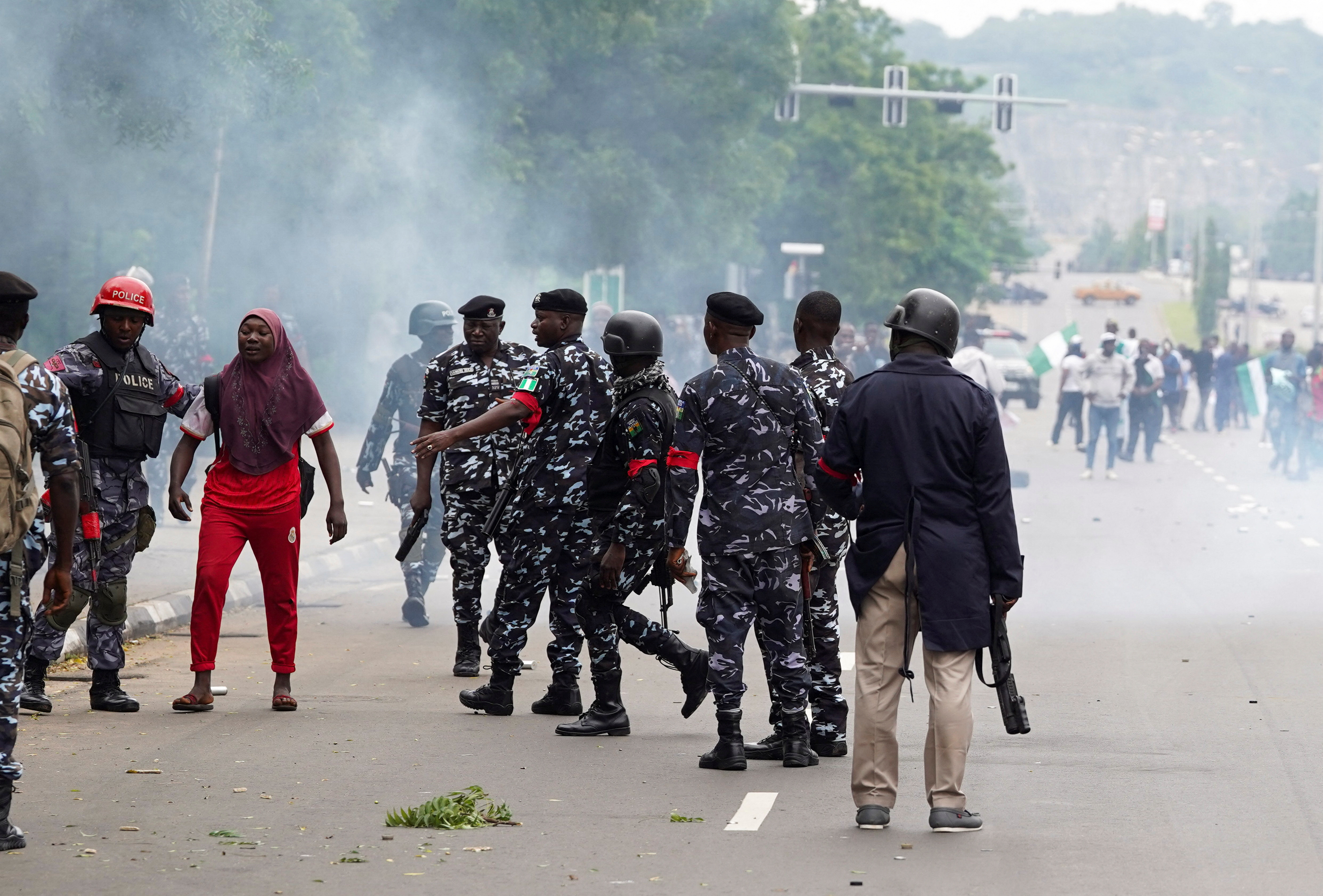 Nigerian security detain a demonstrator, during a protest against bad governance and economic hardship in Abuja, Nigeria