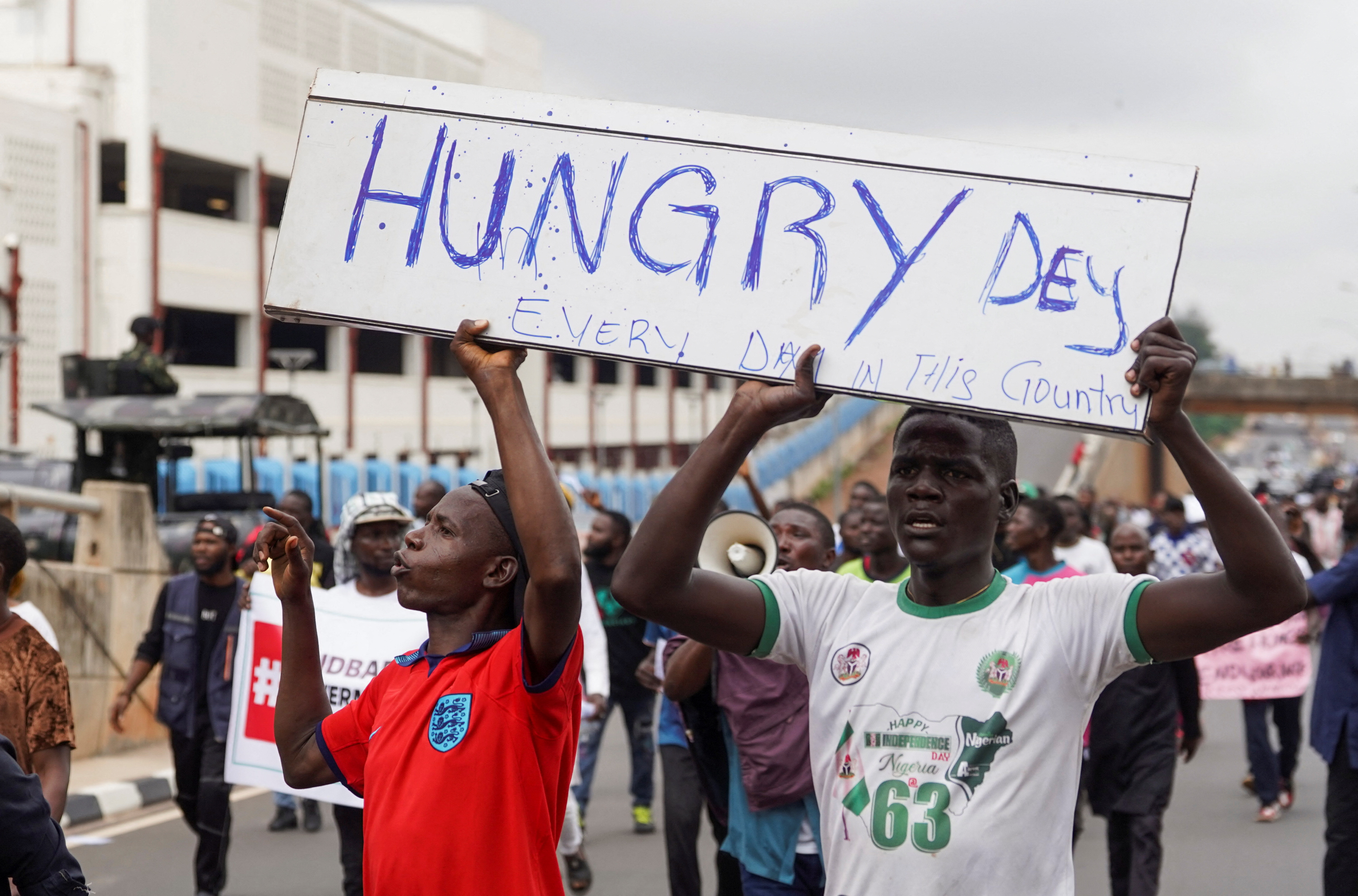 Demonstrators hold a placard, during an anti-government demonstration to protest against bad governance and economic hardship in Abuja