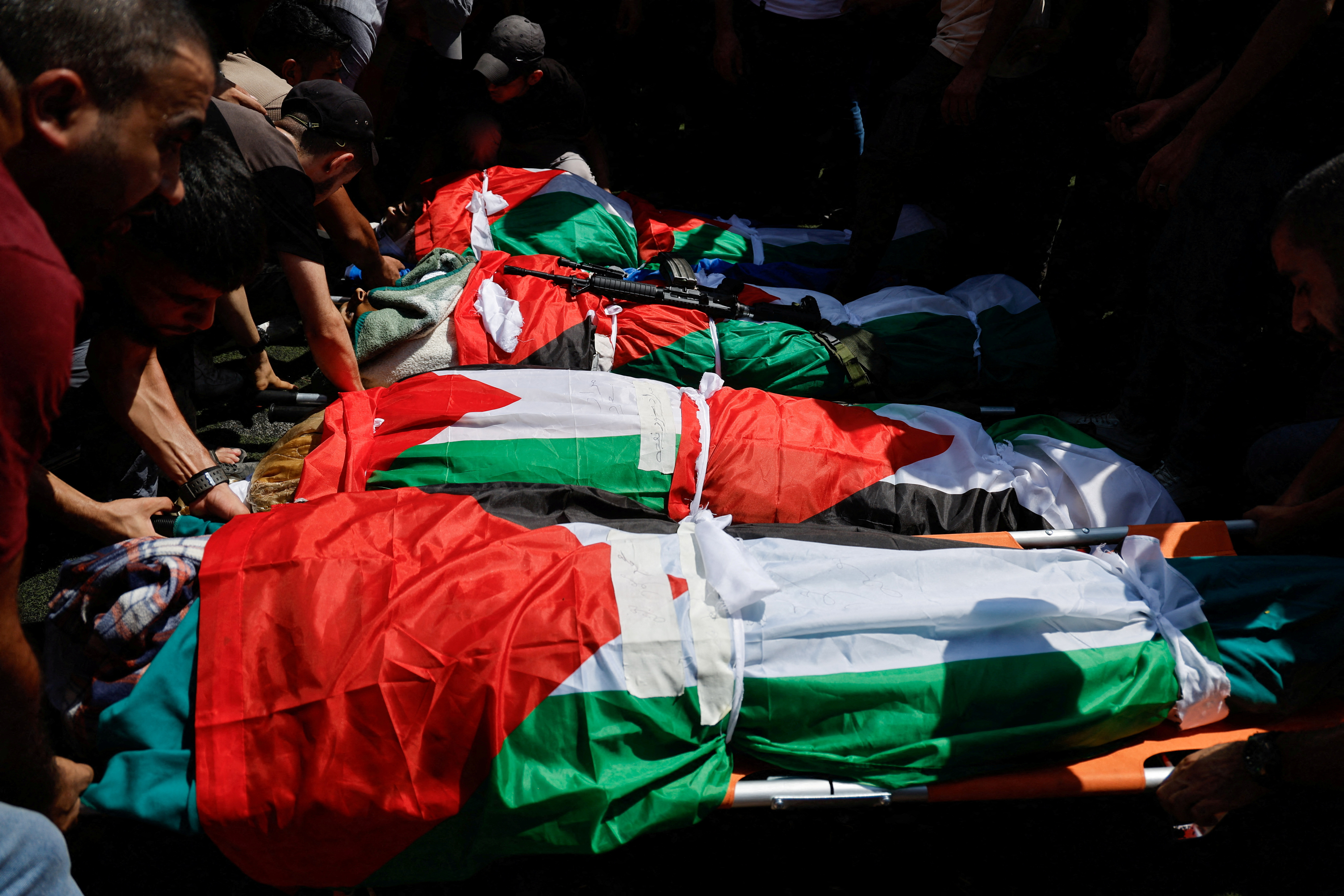 SENSITIVE MATERIAL. THIS IMAGE MAY OFFEND OR DISTURB Mourners stand next to the bodies during a funeral of four Palestinians killed in an Israeli airstrike on Al-Faraa camp, near Tubas, in the Israeli-occupied West Bank, August 29, 2024. REUTERS/Raneen Sawafta TPX IMAGES OF THE DAY