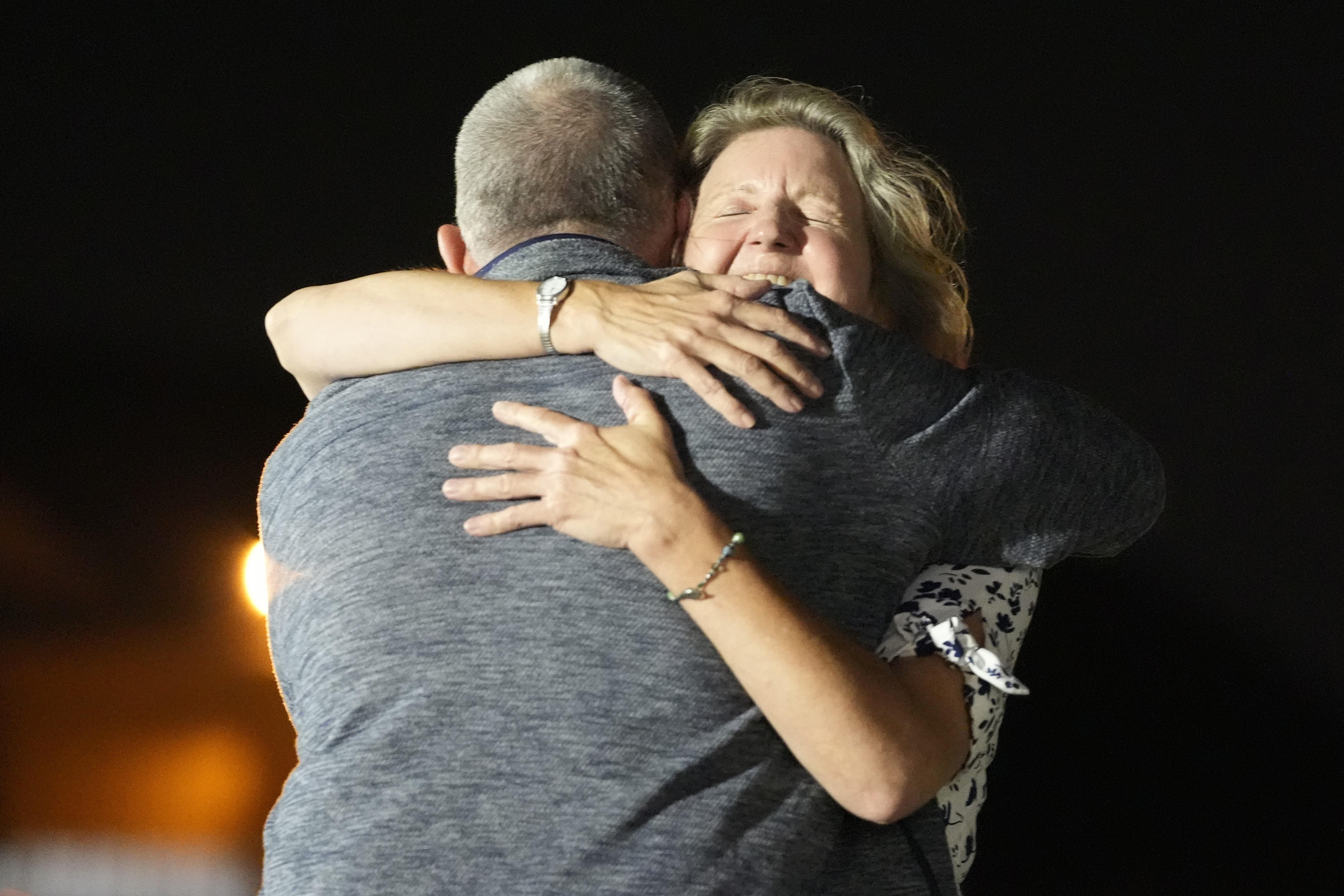 Elizabeth Whelan hugs her brother as he returns to the US. She looks elated.