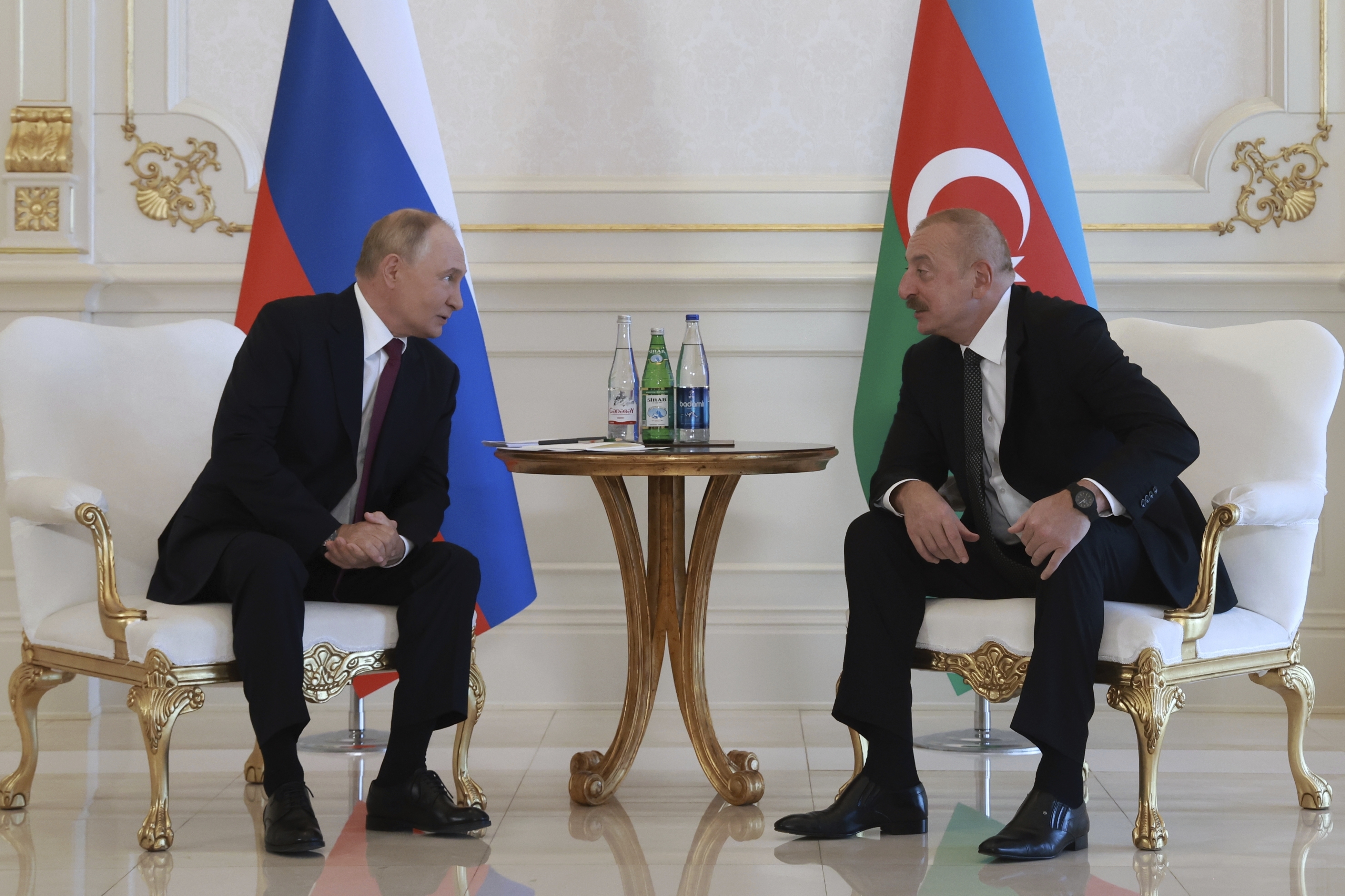 Russian President Vladimir Putin, left, speaks with Azerbaijani President Ilham Aliyev, right, during their meeting at Zagulba state residence in Baku, Azerbaijan, Monday, Aug. 19, 2024. (Vyacheslav Prokofyev, Sputnik, Kremlin Pool Photo via AP)
