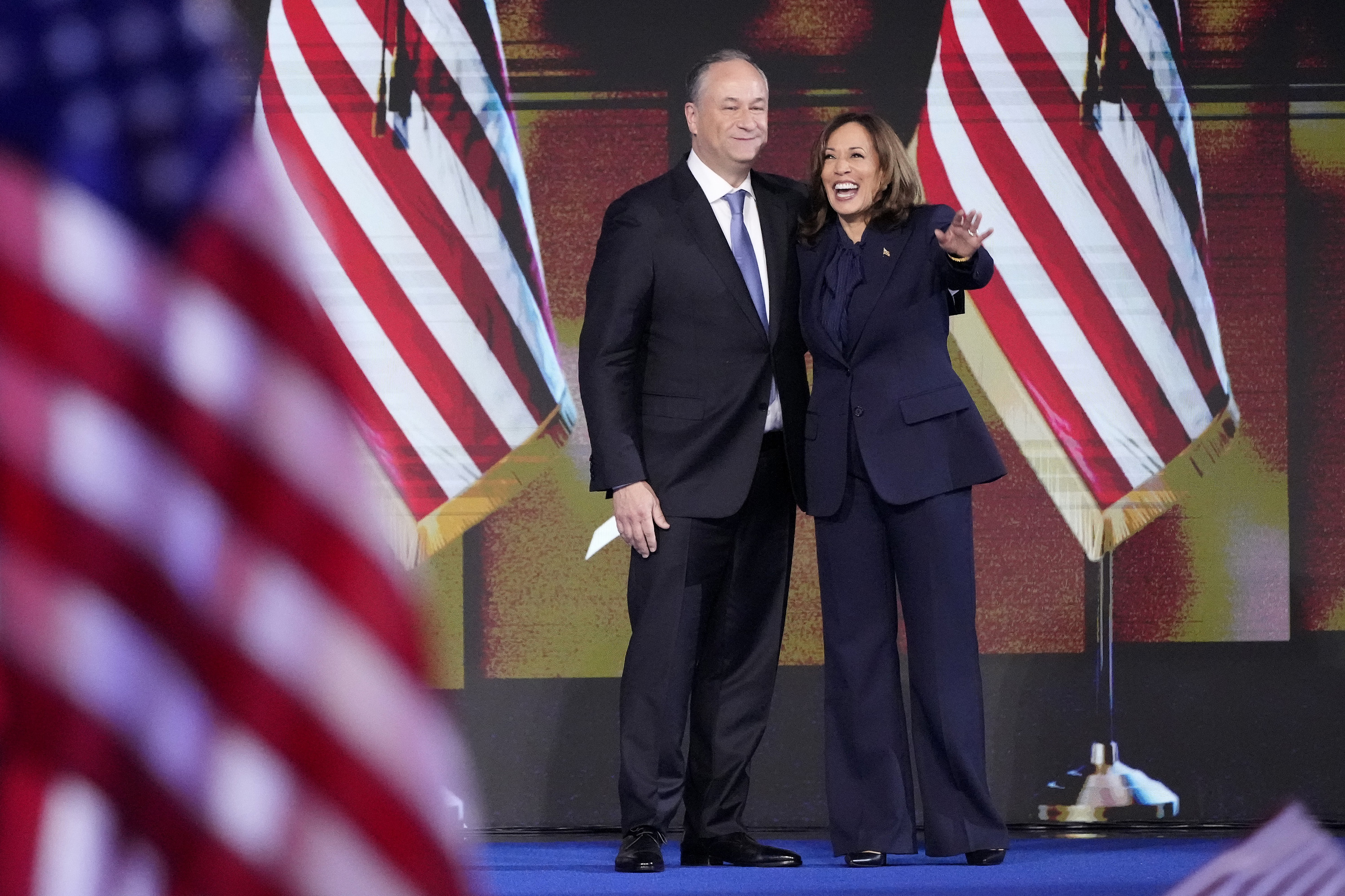 Doug Emhoff and Kamala Harris with US flags