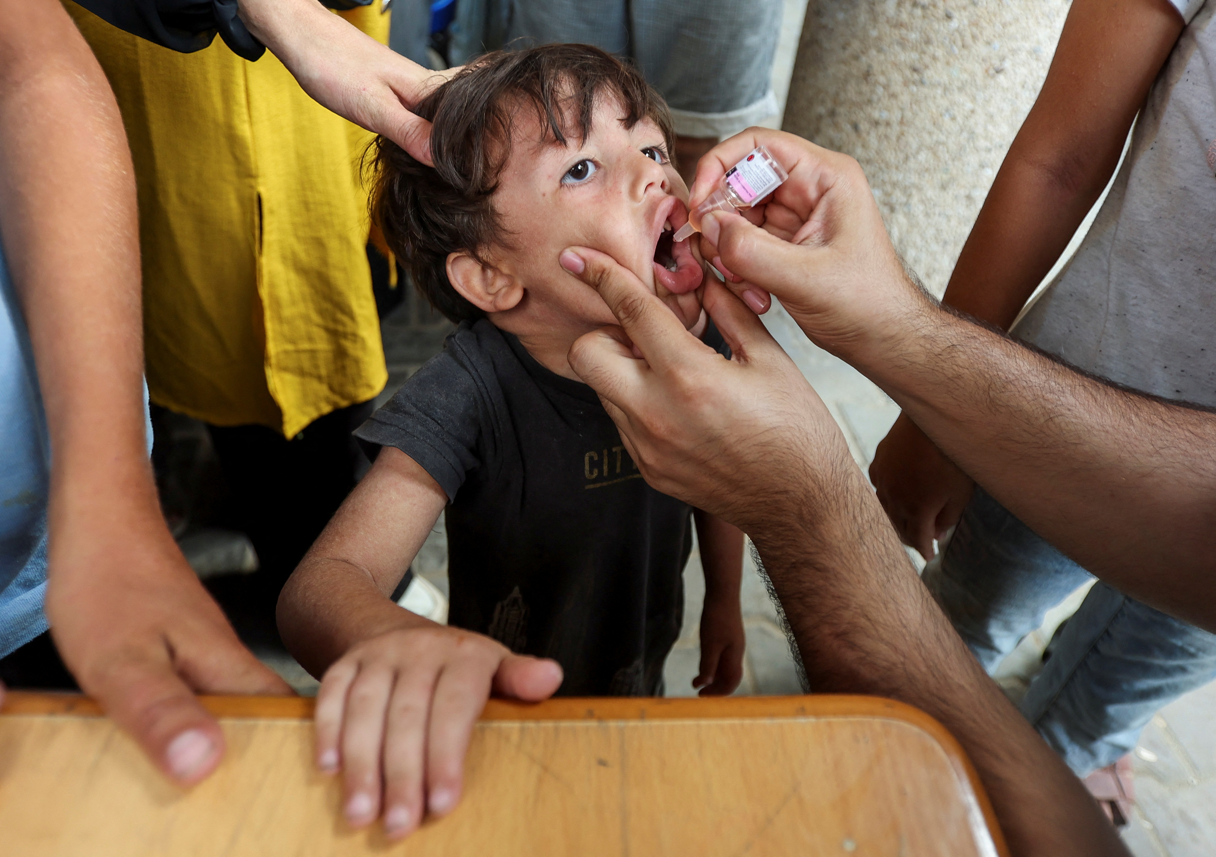 A Palestinian child is vaccinated against polio, at a United Nations healthcare center in Deir Al-Balah in the central Gaza Strip, September 1, 2024. REUTERS/Ramadan Abed