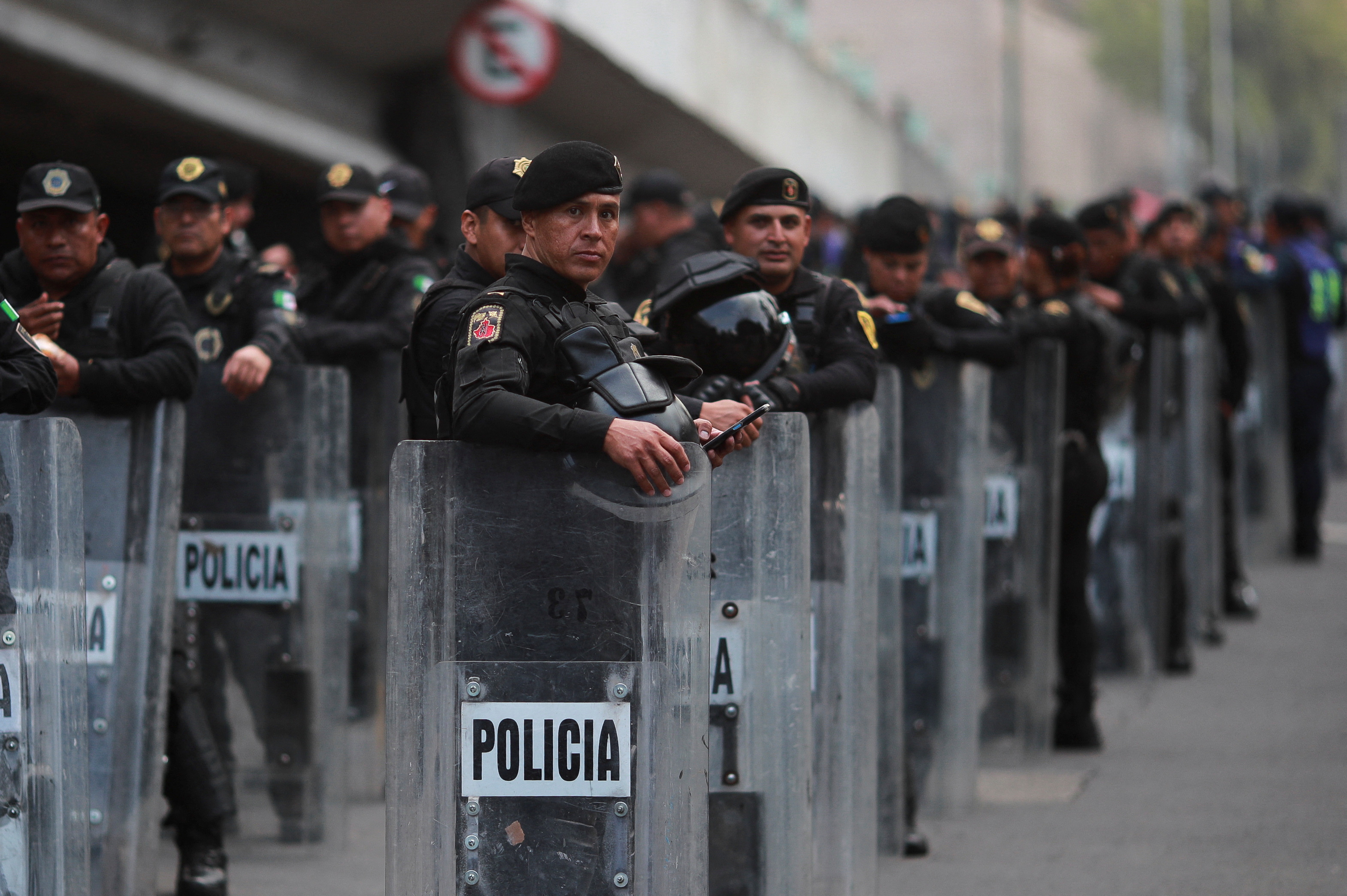 A line of police with riot shields