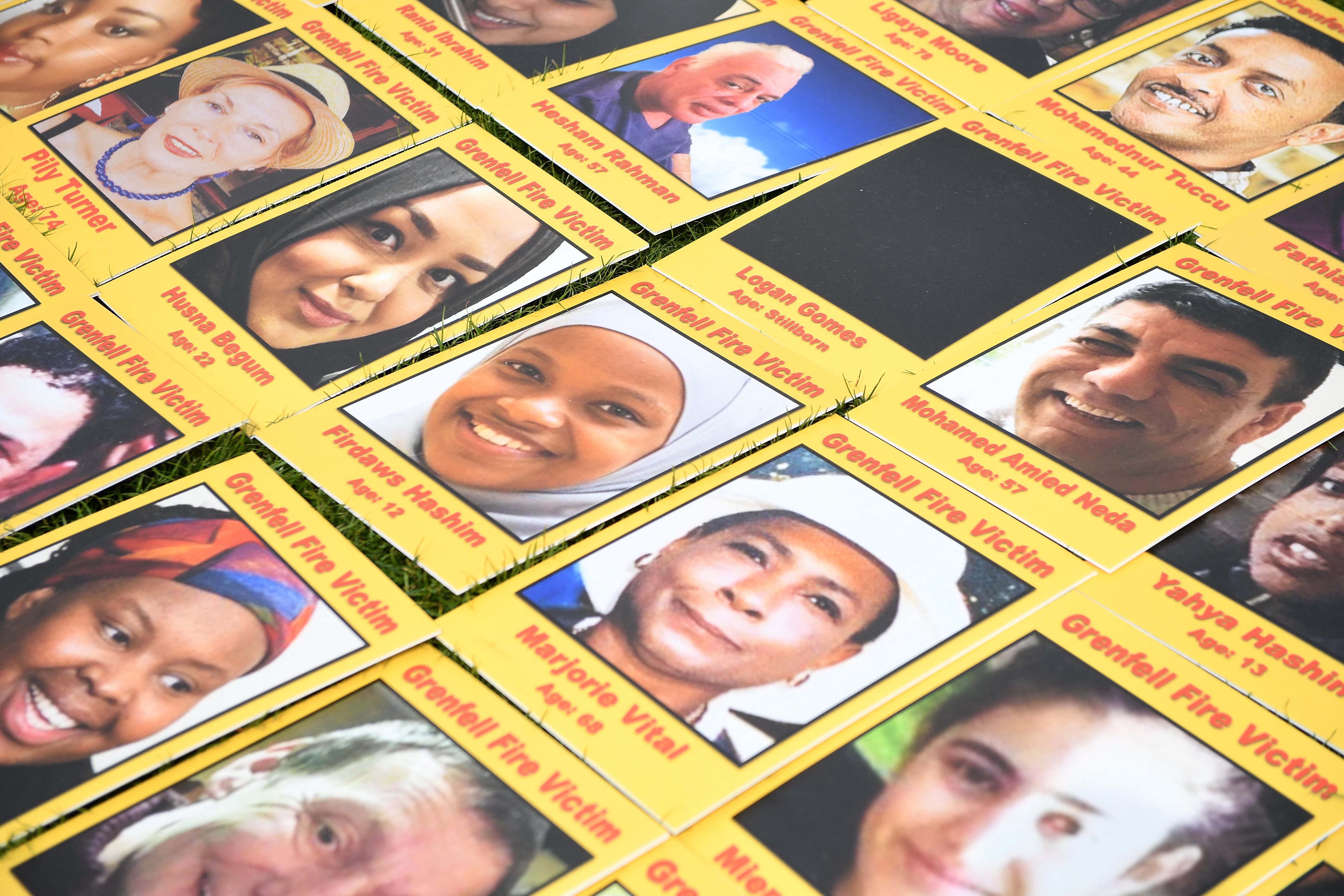 Demonstrators calling for justice for the victims of the Grenfell Tower fire, place images of the deceased on Parliament Square during a protest opposite the Houses of Parliament in central London