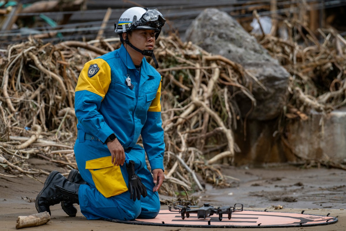 Rescuers comb muddy riverbanks after Japan floods kill six