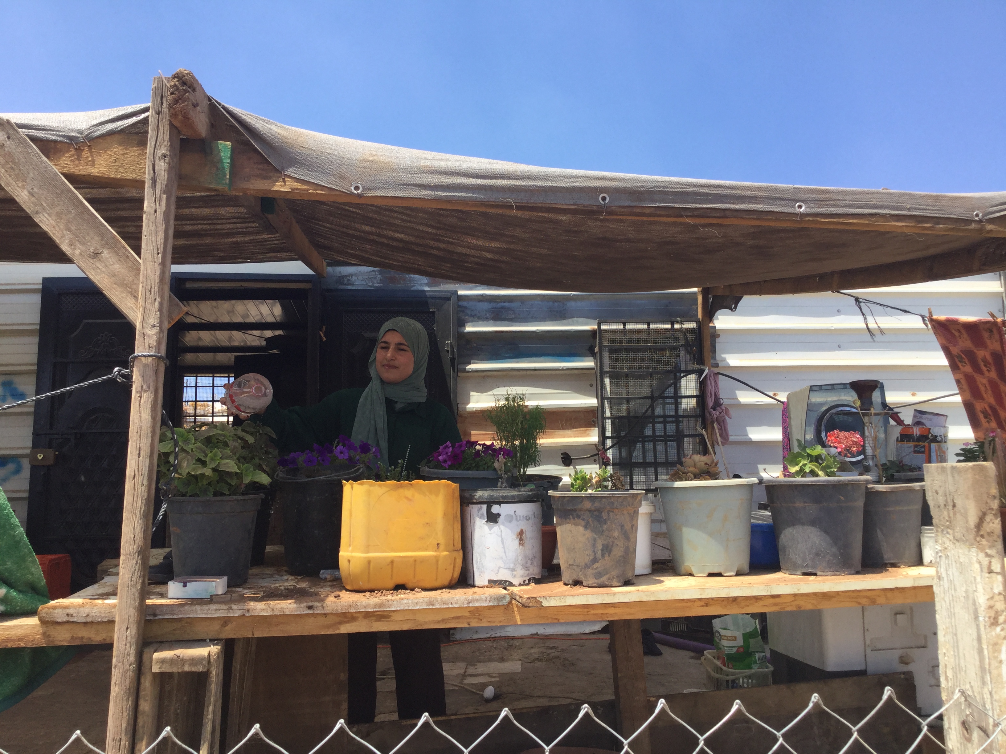 Ekhlas watering her plants