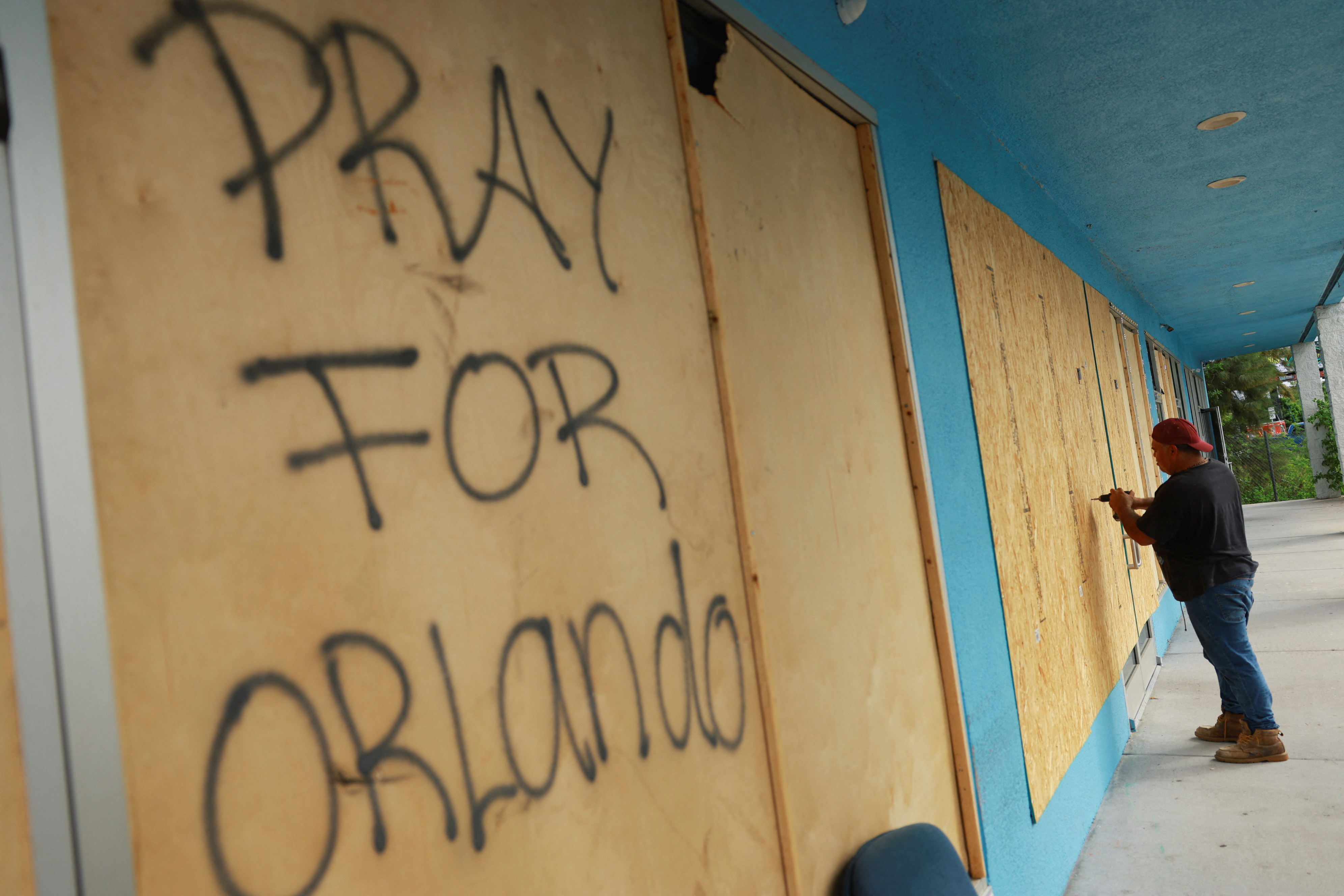 "Pray for Orlando" reads on wood that was placed at a Home Depot before the arrival of Hurricane Milton.