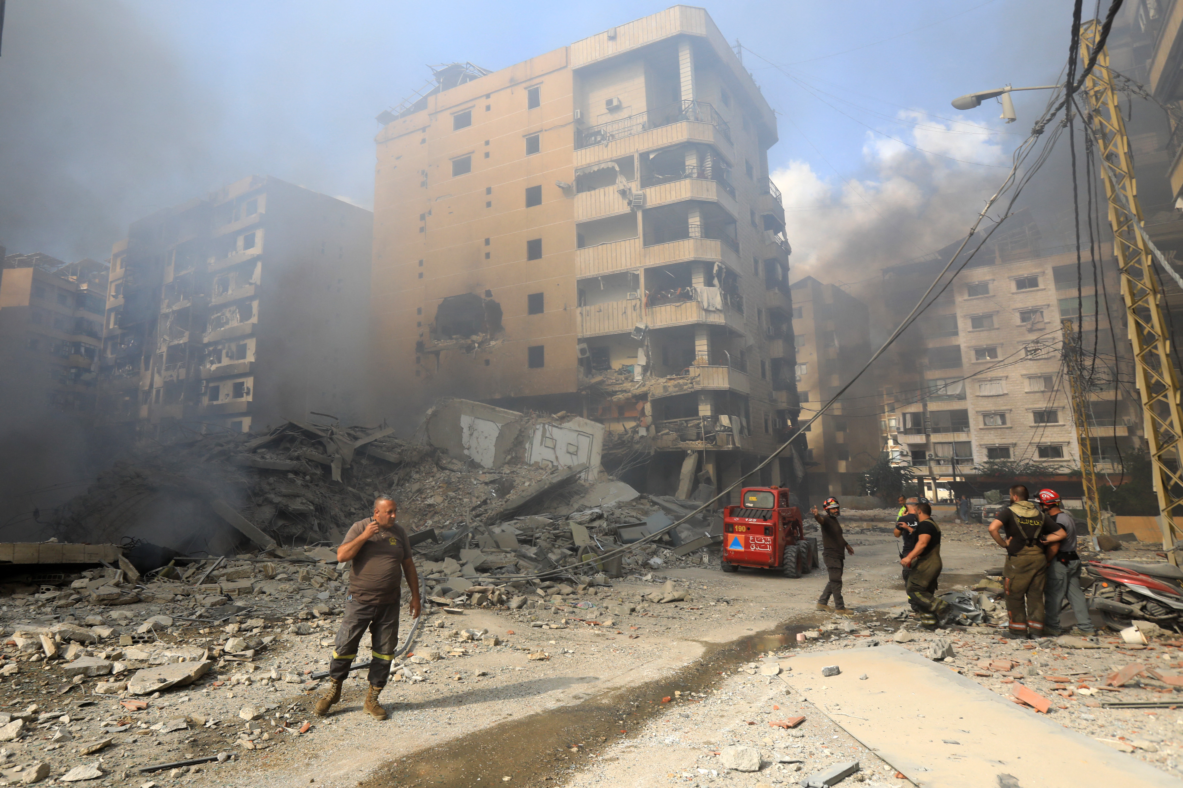 Firefighters work at the site of an overnight Israeli airstrike in Beirut's southern suburb of Shayyah on October 2