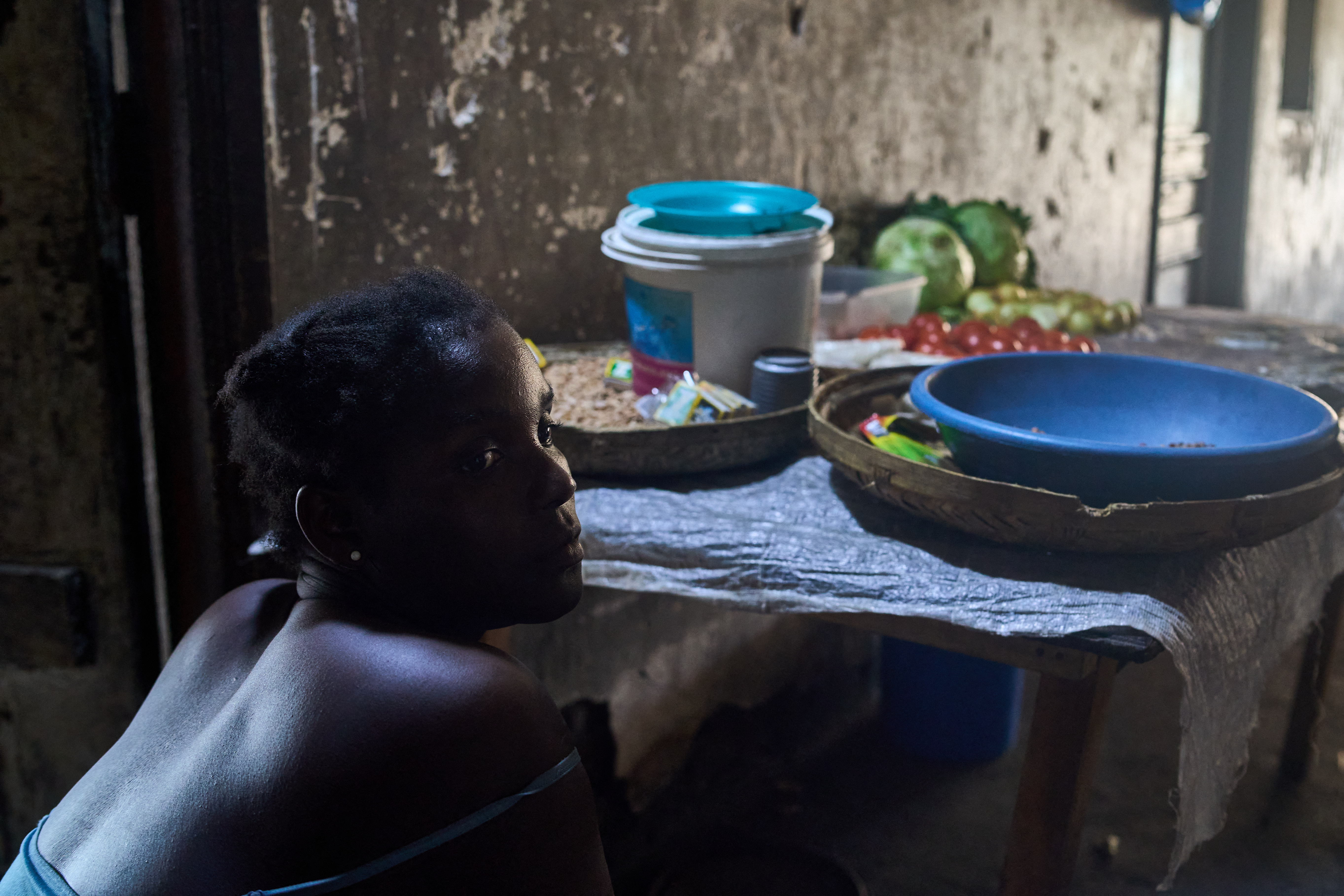 A woman sells vegetables at a stall in the hallway of the Grande Hotel in Beira on October 12