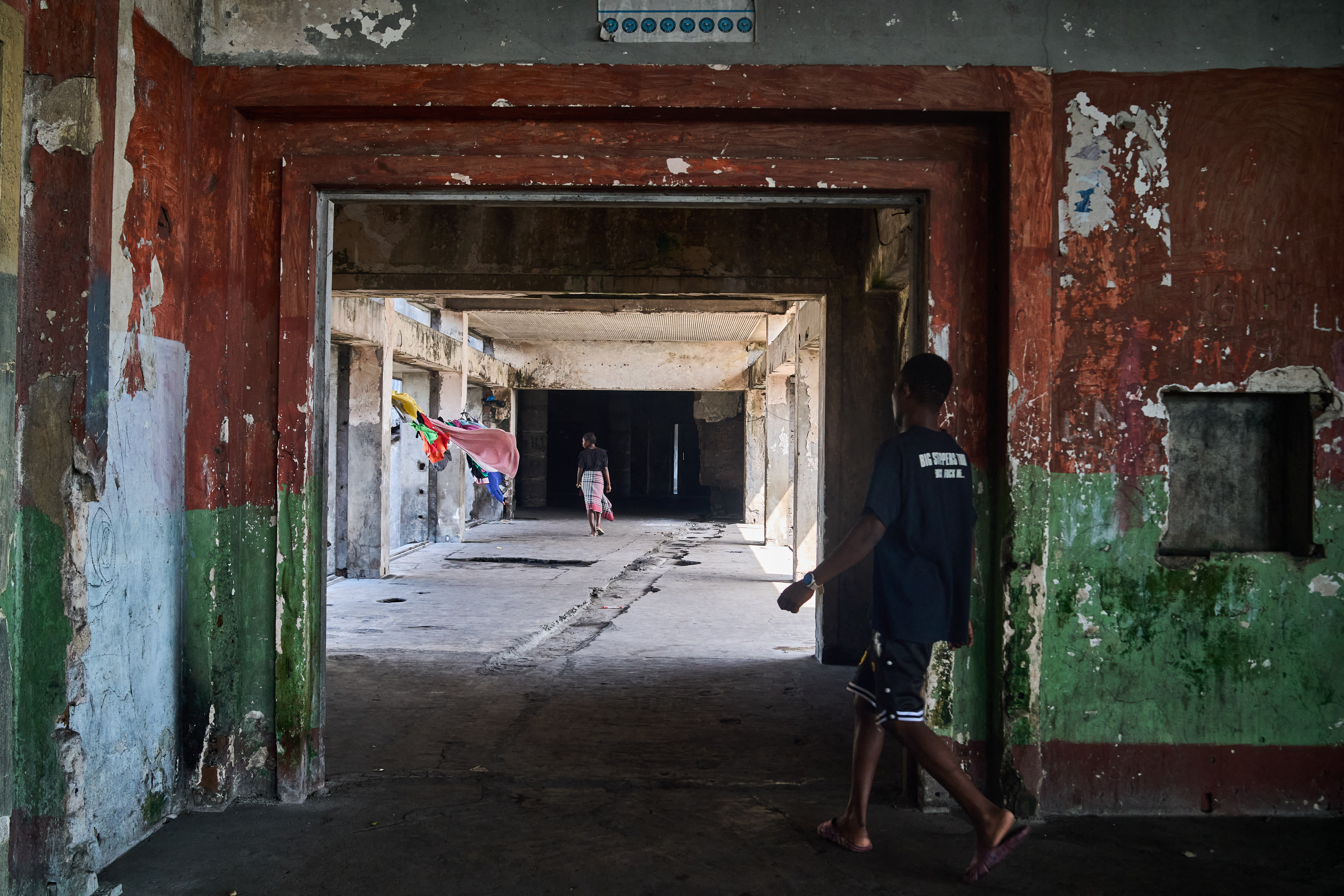 People walk in the hallway inside the Grande Hotel in Beira on October 12