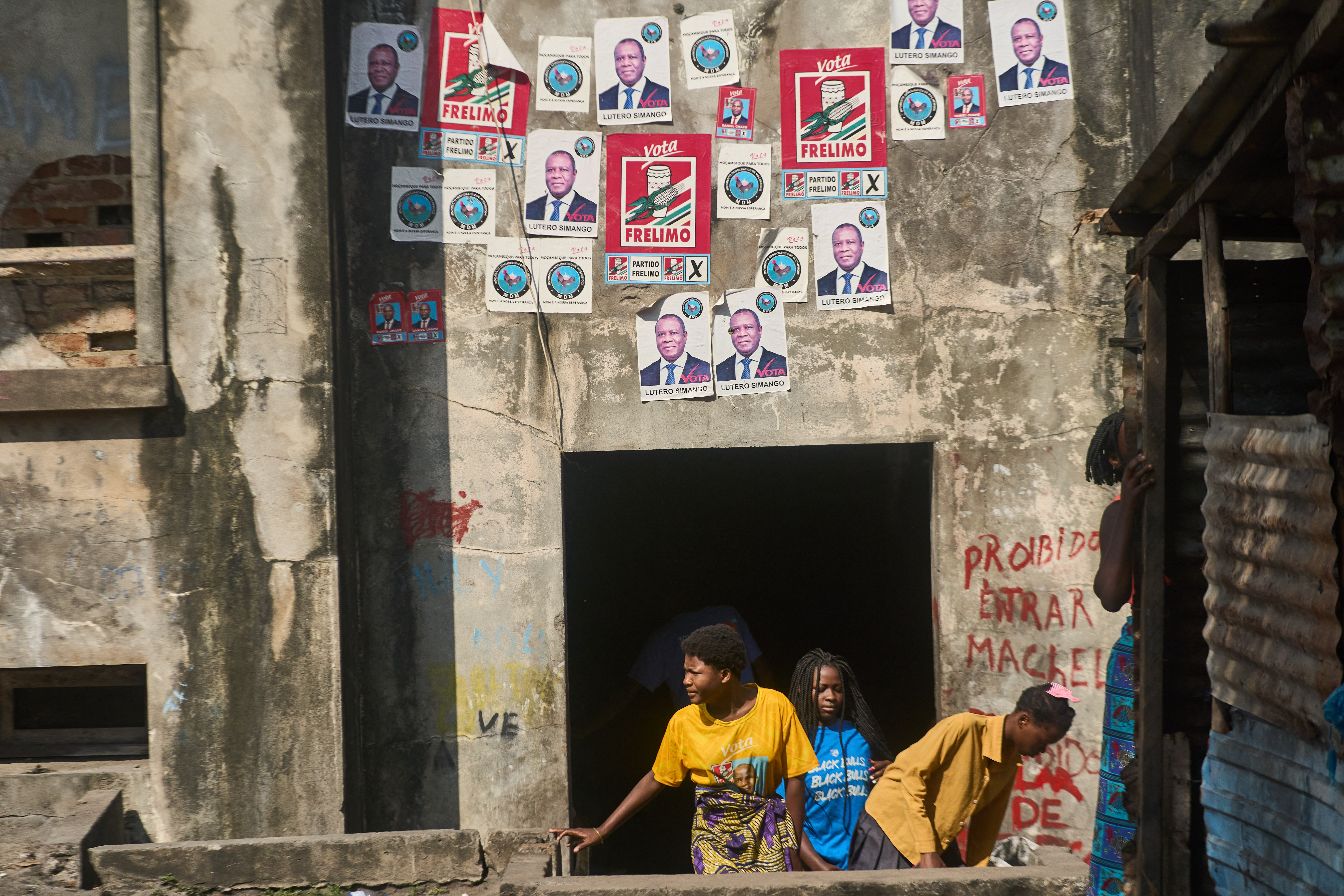 Women walk out of the Grande Hotel in Beira on October 12