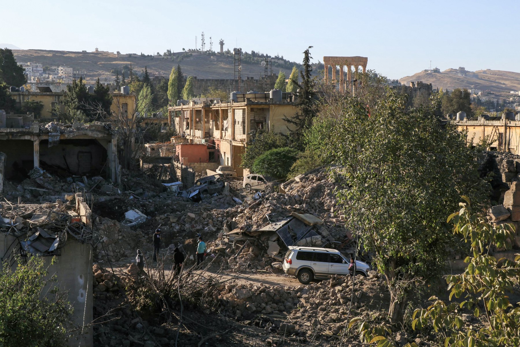 People inspect the destruction at the site of an overnight Israeli air attack in Baalbek