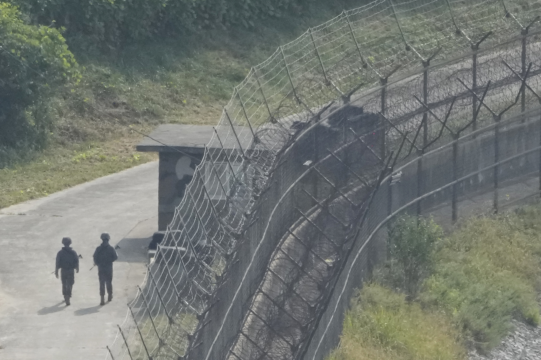 South Korean army soldiers patrol along the barbed-wire fence in Paju, South Korea,