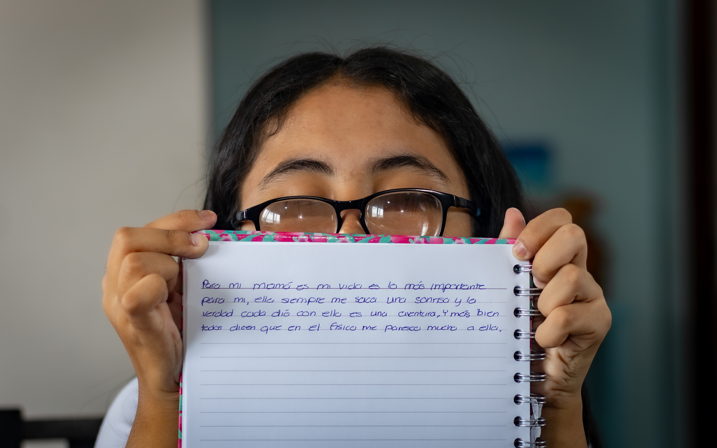 My name is Camila Valverde from Costa Rica, and I describe the love I have for my mom in what is written here: every word on this piece of paper reflects the moments we have shared and the unbreakable bond between us [Diego Francisco Sánchez Lázaro/Al Jazeera]