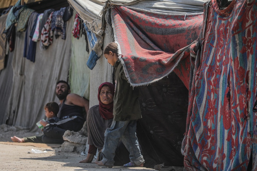 epa11597090 Internally displaced Palestinians, who fled from the northern Gaza Strip, sit outside their shelter in Khan Yunis, southern Gaza Strip, 10 September 2024. According to the UN aid coordination office OCHA, Israeli security forces have issued at least 16 evacuation orders in August 2024, impacting about 12 percent of Gaza's population, or 258,000 people. Since October 2023, only about 11 percent of the Gaza Strip has not been placed under evacuation orders, the office added. According to the UN, at least 1.9 million people across the Gaza Strip are internally displaced, including people who have been repeatedly displaced. More than 40,000 Palestinians and over 1,400 Israelis have been killed, according to the Palestinian Health Ministry and the Israel Defense Forces (IDF), since Hamas militants launched an attack against Israel from the Gaza Strip on 07 October 2023, and the Israeli operations in Gaza and the West Bank which followed it. EPA-EFE/MOHAMMED SABER