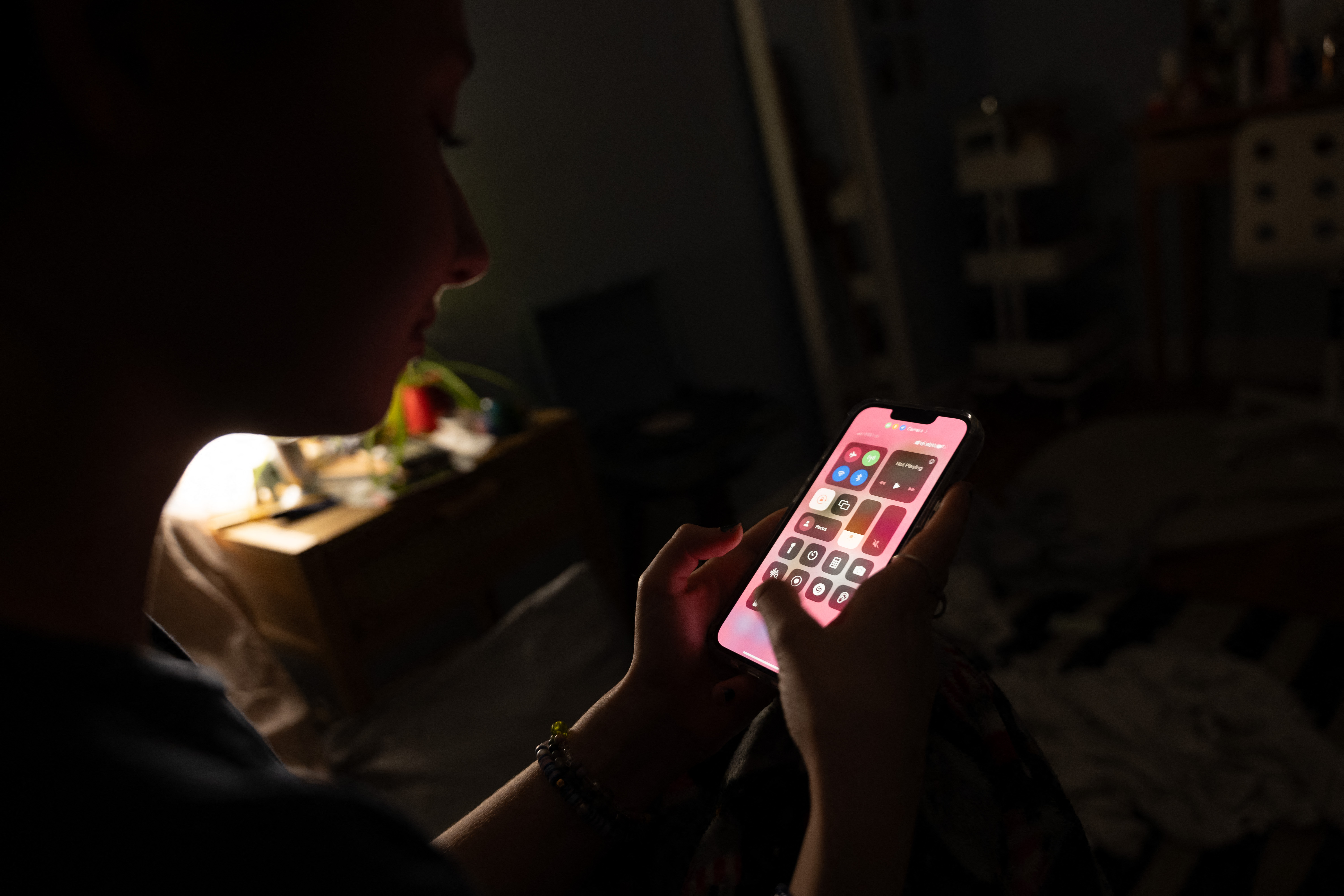 NEW YORK, NEW YORK - JANUARY 31: In this photo illustration, a teenager uses her mobile phone to access social media on January 31, 2024 in New York City. Technology executives appeared at a Senate hearing to address accusations that their companies are endangering children's lives by not adequately policing predators and others who seek to harm and exploit young social media users. (Photo illustration by Spencer Platt/Getty Images) (Photo by SPENCER PLATT / GETTY IMAGES NORTH AMERICA / Getty Images via AFP)