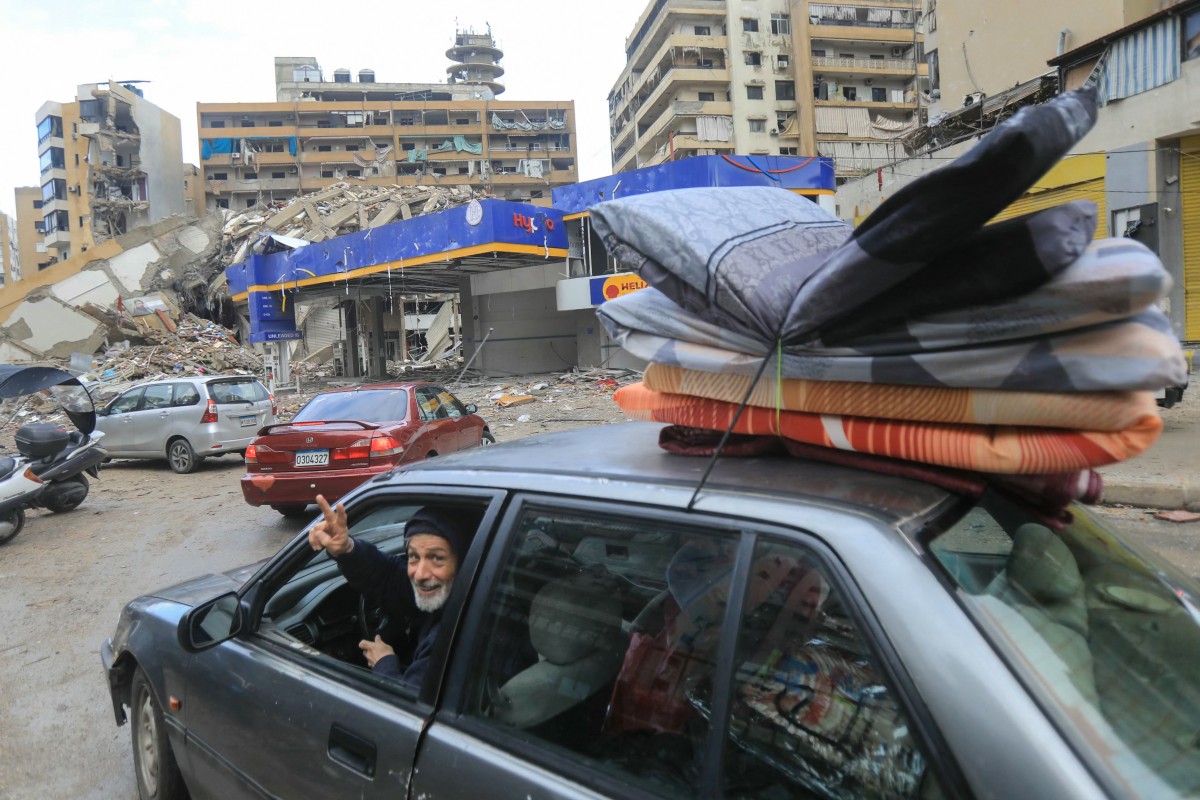 People return with their belongings to their homes in Beirut's southern suburbs after a ceasefire between Israel and Hezbollah took effect
