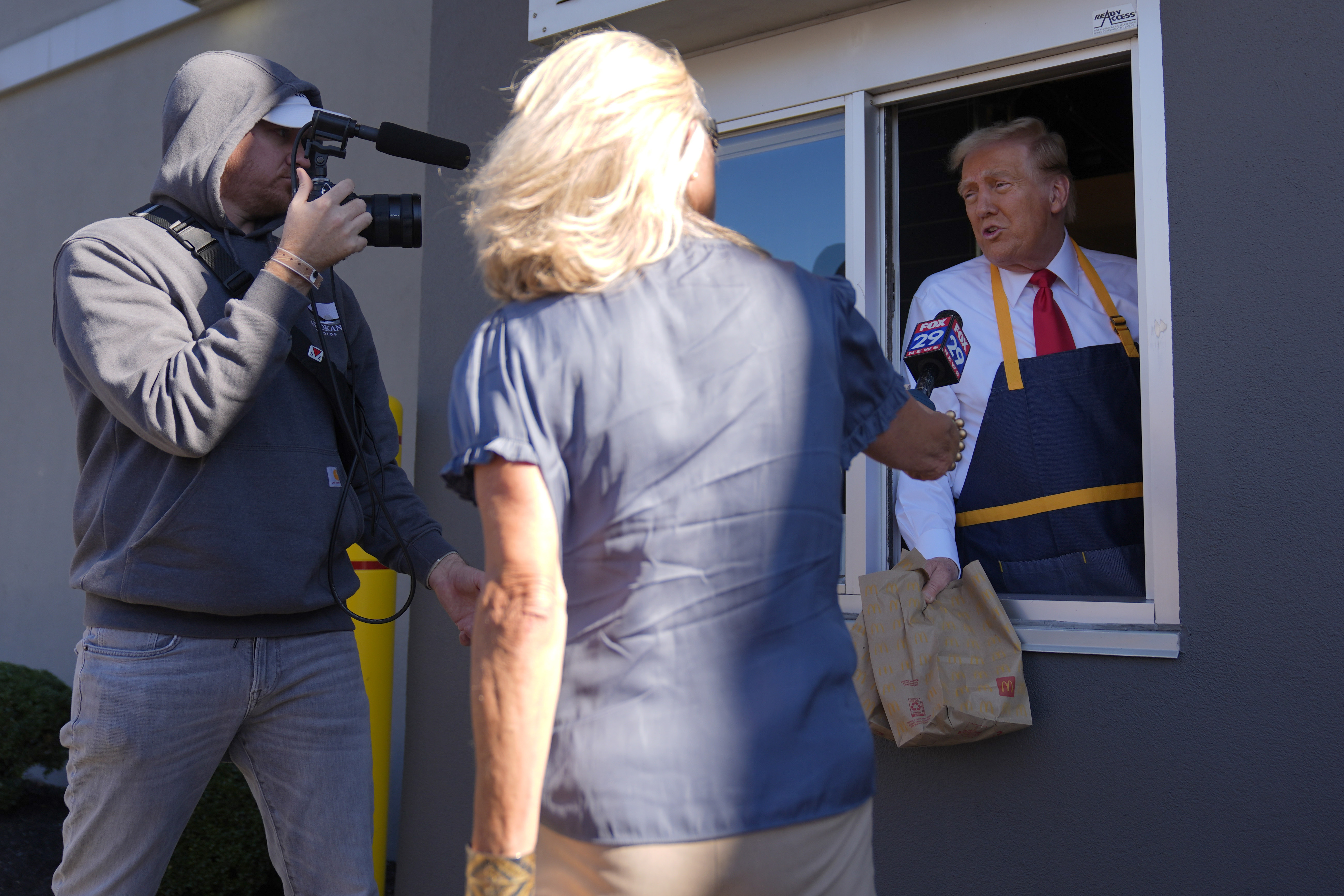 Donald Trump is interviewed through a drive-thru window at McDonald's