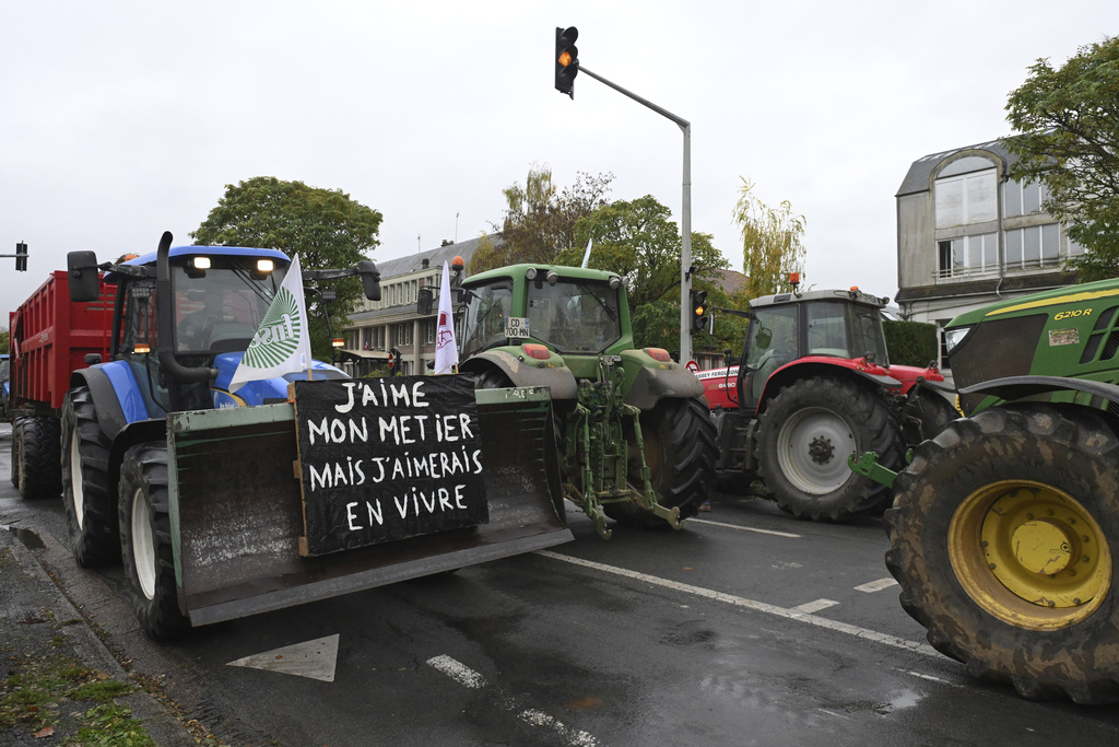 Farmers drive their tractors during a rally.