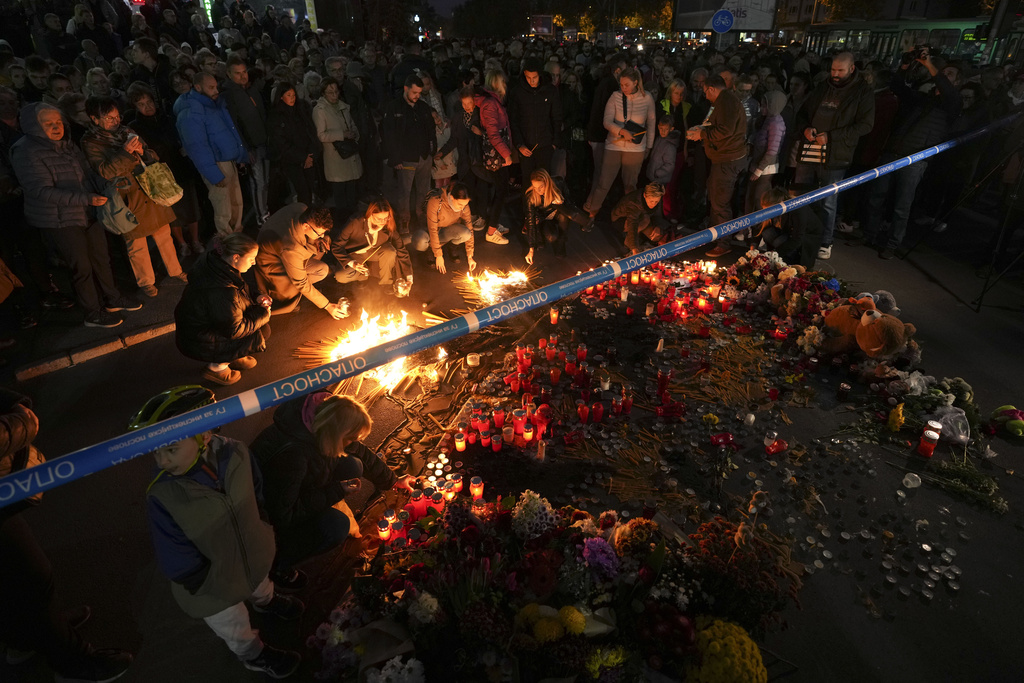 People light candles for the victims after an outdoor roof collapsed at a train station in Novi Sad, Serbia