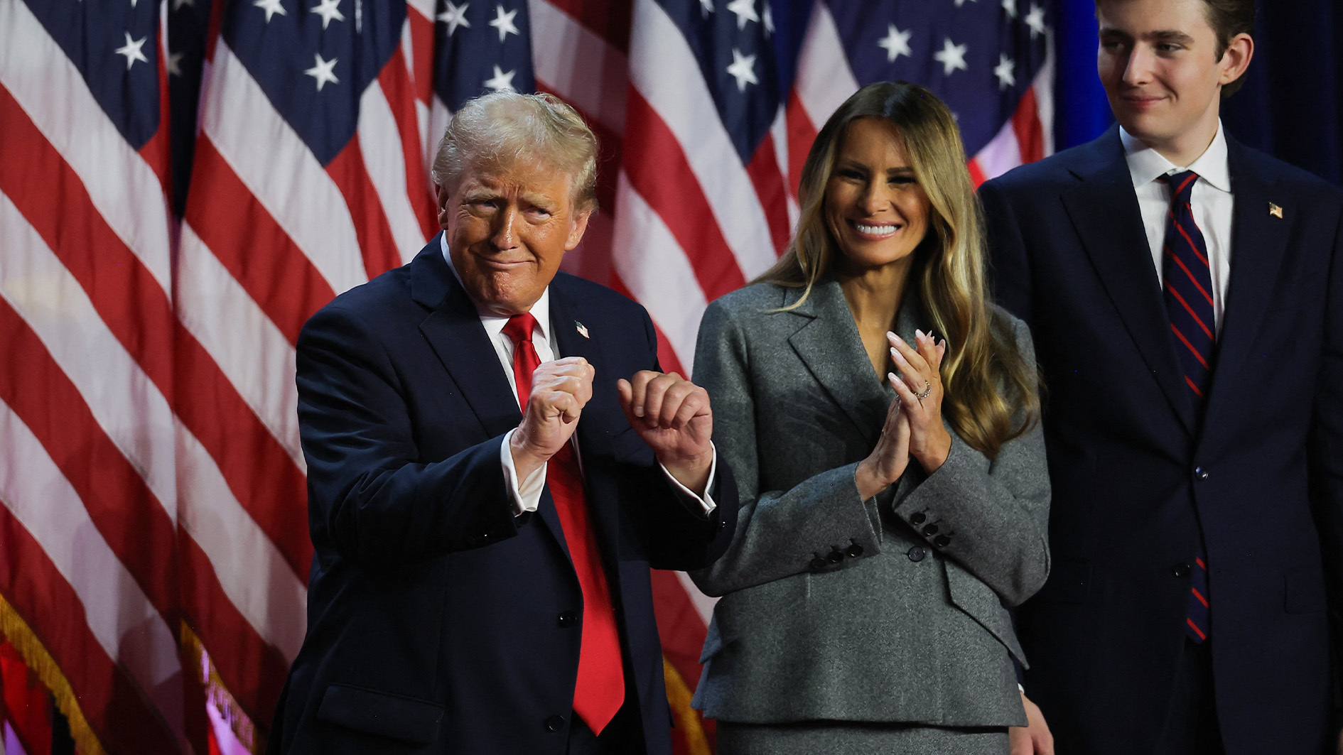 Donald Trump reacts next to his wife Melania Trump and son Barron Trump