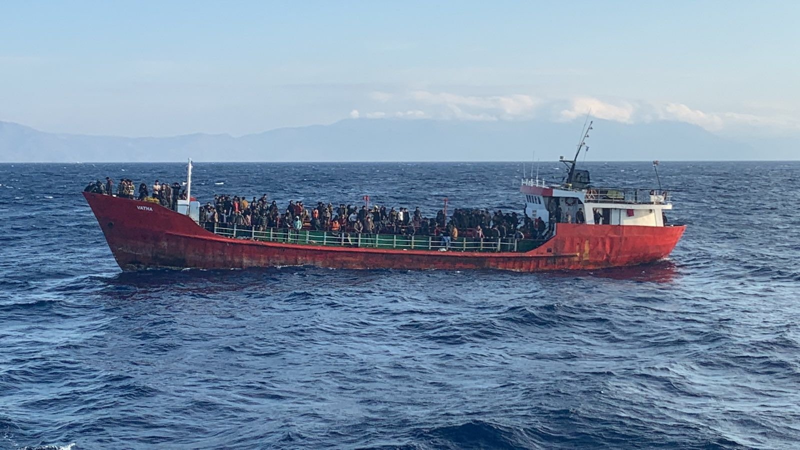 A cargo ship carries asylum seekers during a rescue operation as it sails off the Greek island of Crete