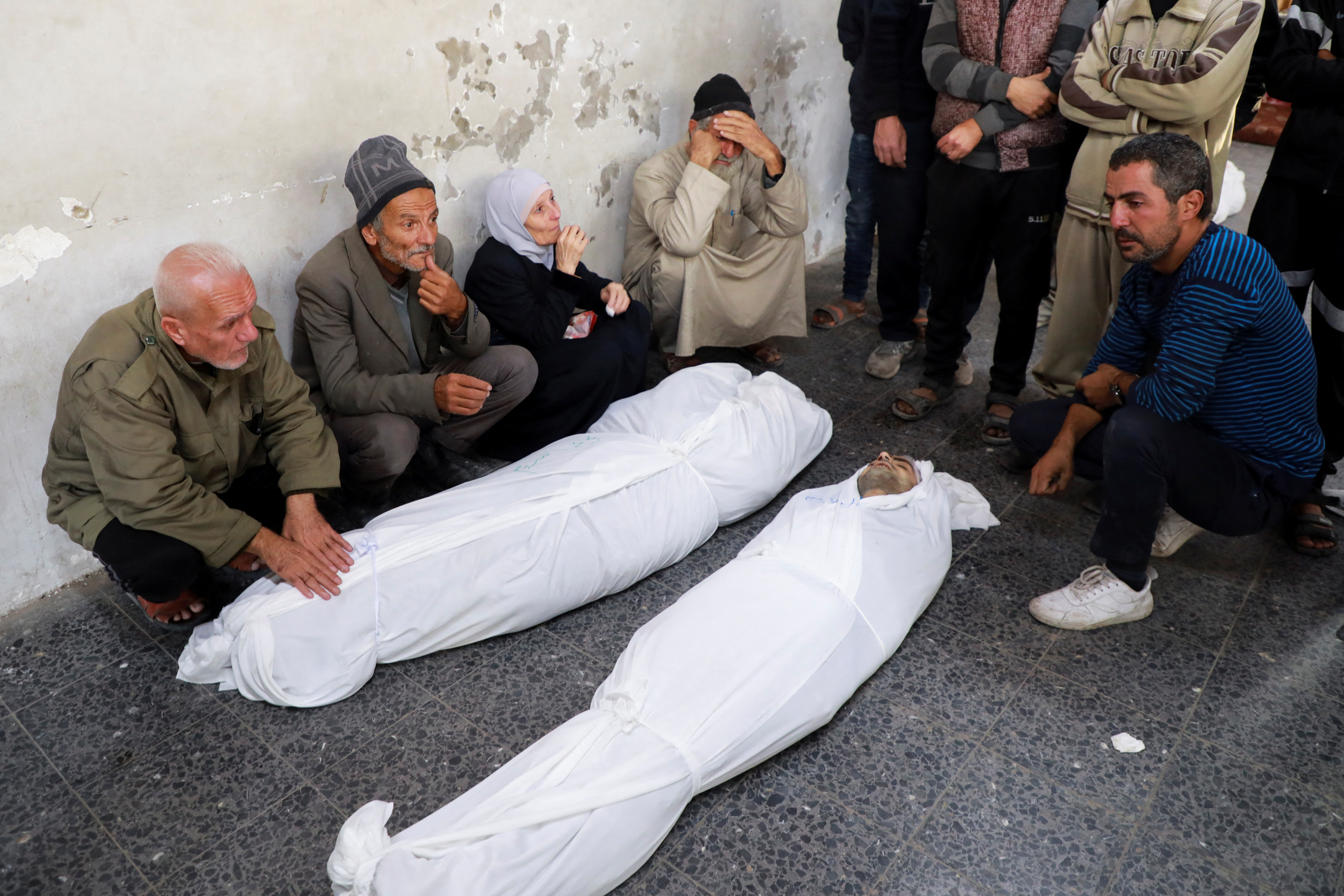 Mourners next to the bodies of Palestinians killed in an Israeli strike at hospital in Gaza City December 3, 2024. [Mahmoud Sameer/Reuters]