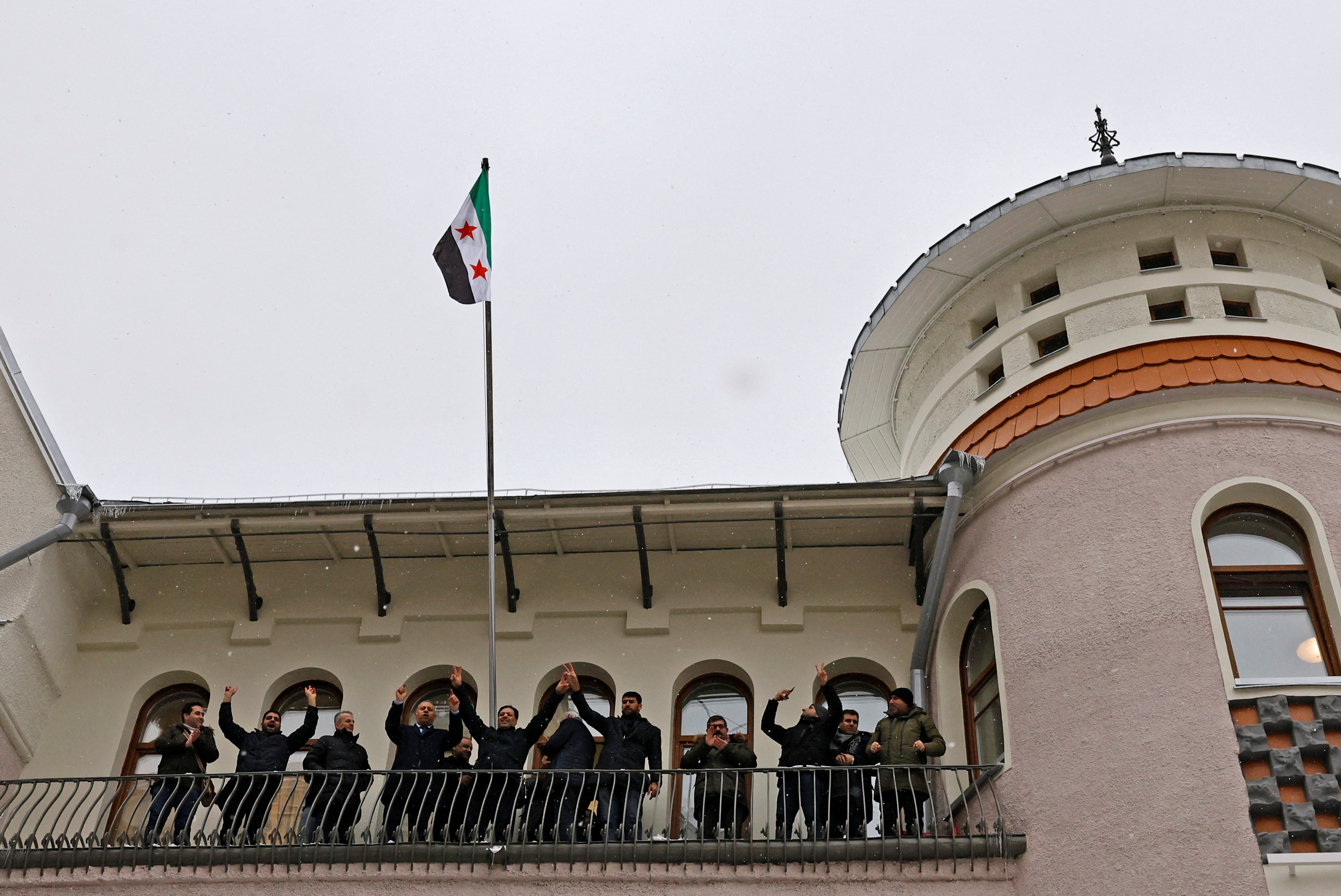 Images with the Syrian opposition flag raised at the embassy in Moscow