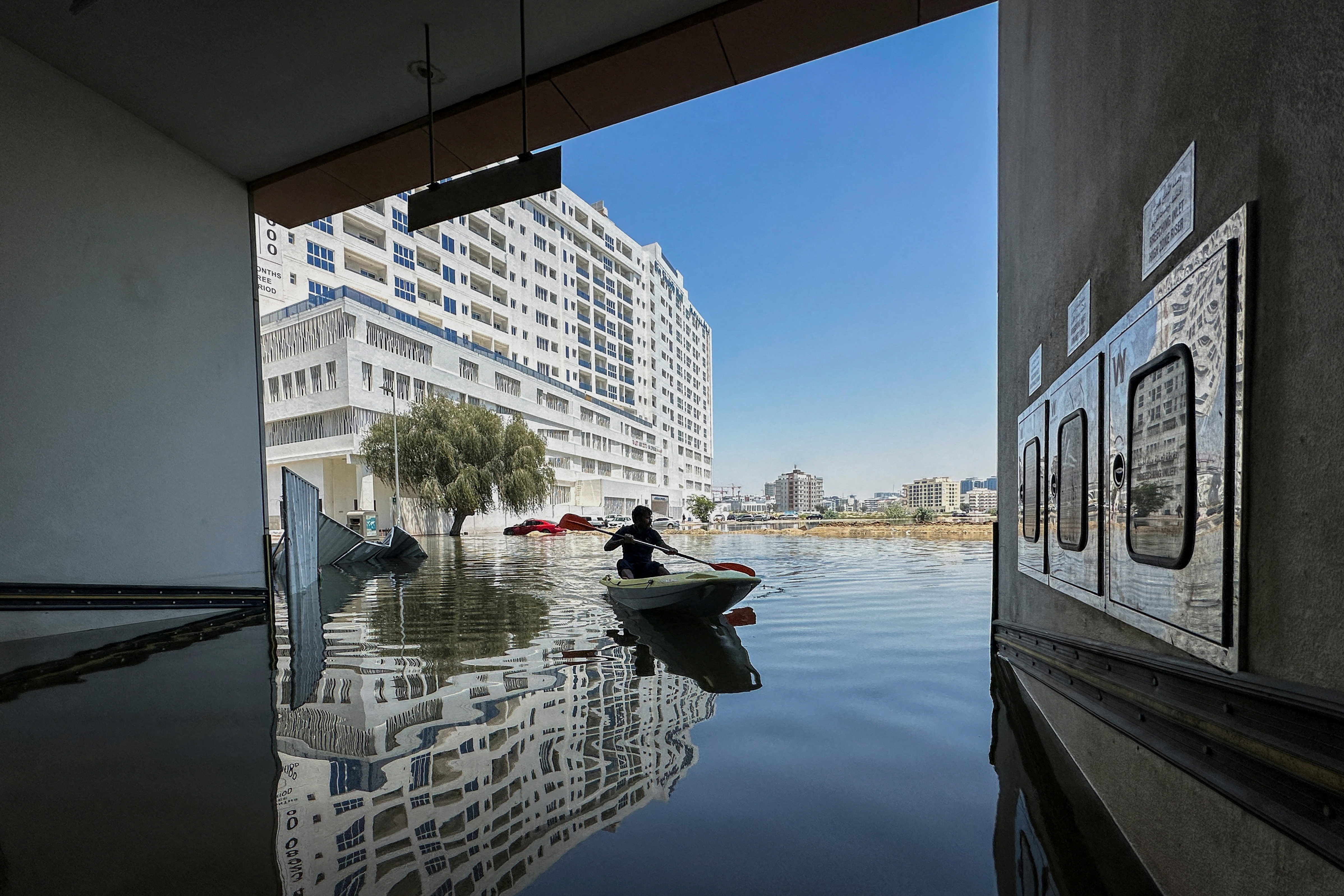 A volunteer uses a kayak during a rescue operation through a road flooded due to heavy rains in Dubai, United Arab Emirates, April 18
