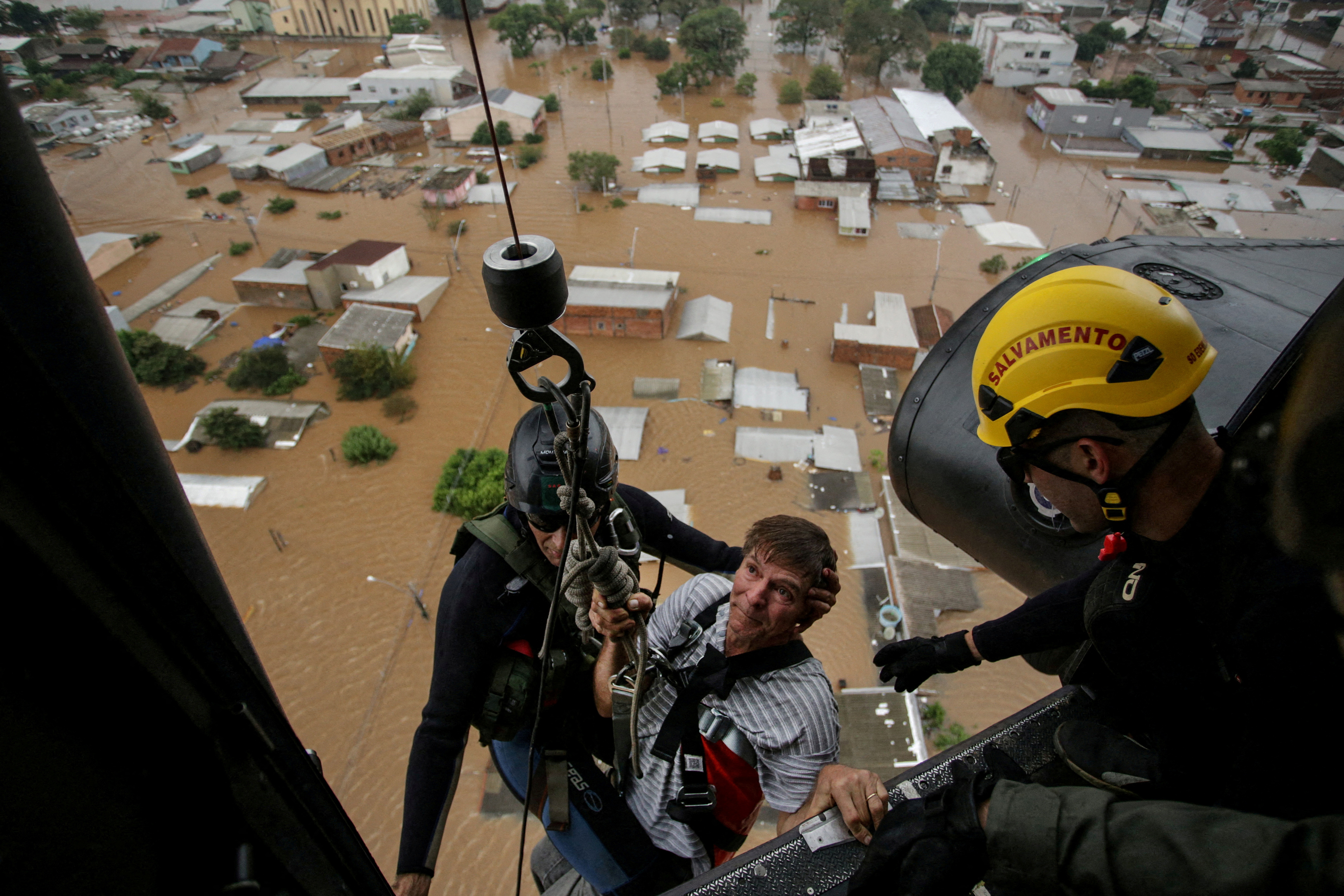 A man is rescued by military firefighters after the floods in Canoas, at the Rio Grande do Sul state, Brazil, May 4
