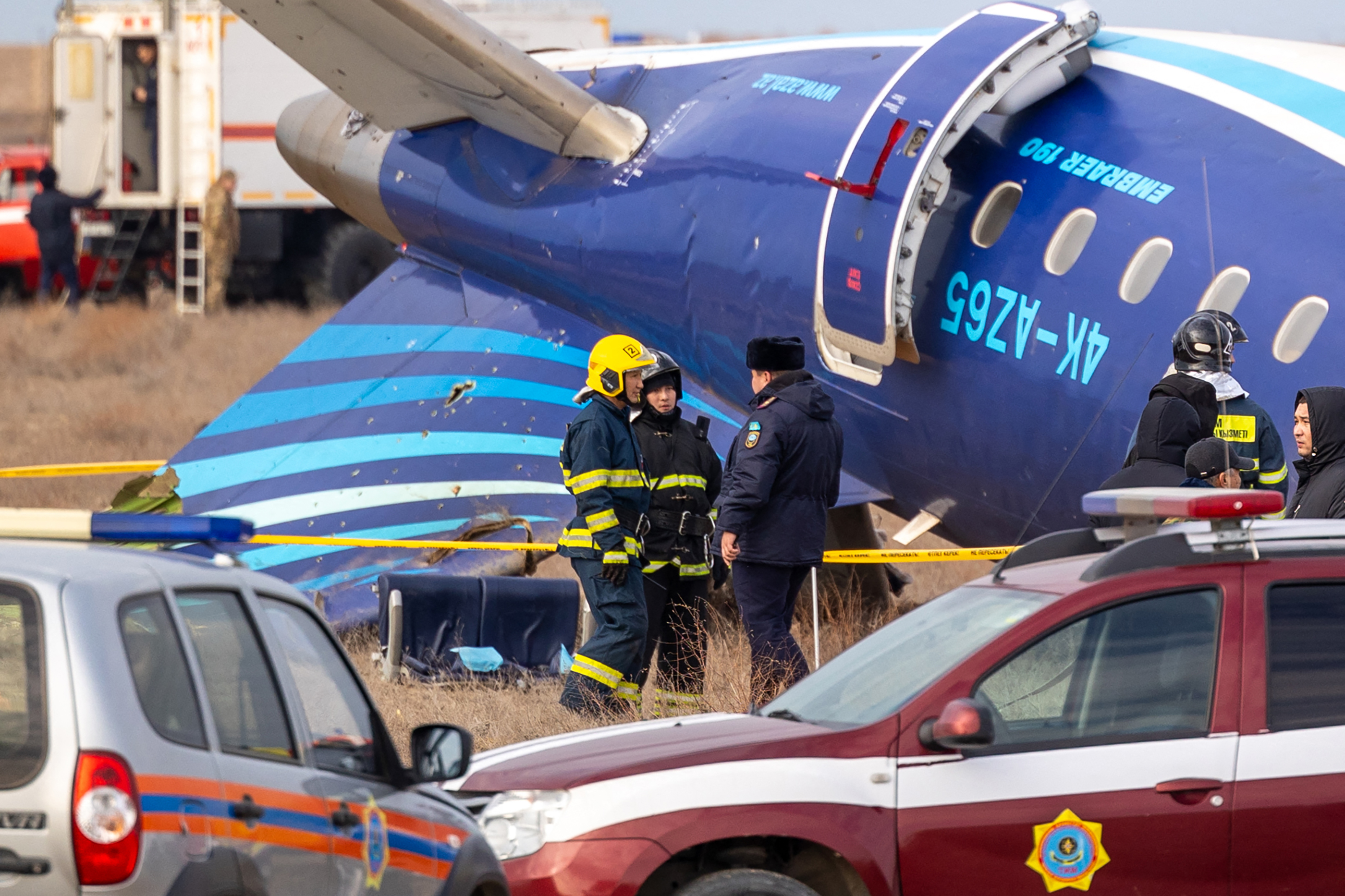 Emergency specialists work at the crash site of an Azerbaijan Airlines passenger jet near the western Kazakh city of Aktau on December 25, 2024. - The Embraer 190 aircraft was supposed to fly northwest from the Azerbaijani capital Baku to the city of Grozny in Chechnya in southern Russia, but instead diverted far off course across the Caspian Sea. It crashed on December 25, 2024 near the city of Aktau in Kazakhstan. (Photo by Issa Tazhenbayev / AFP)