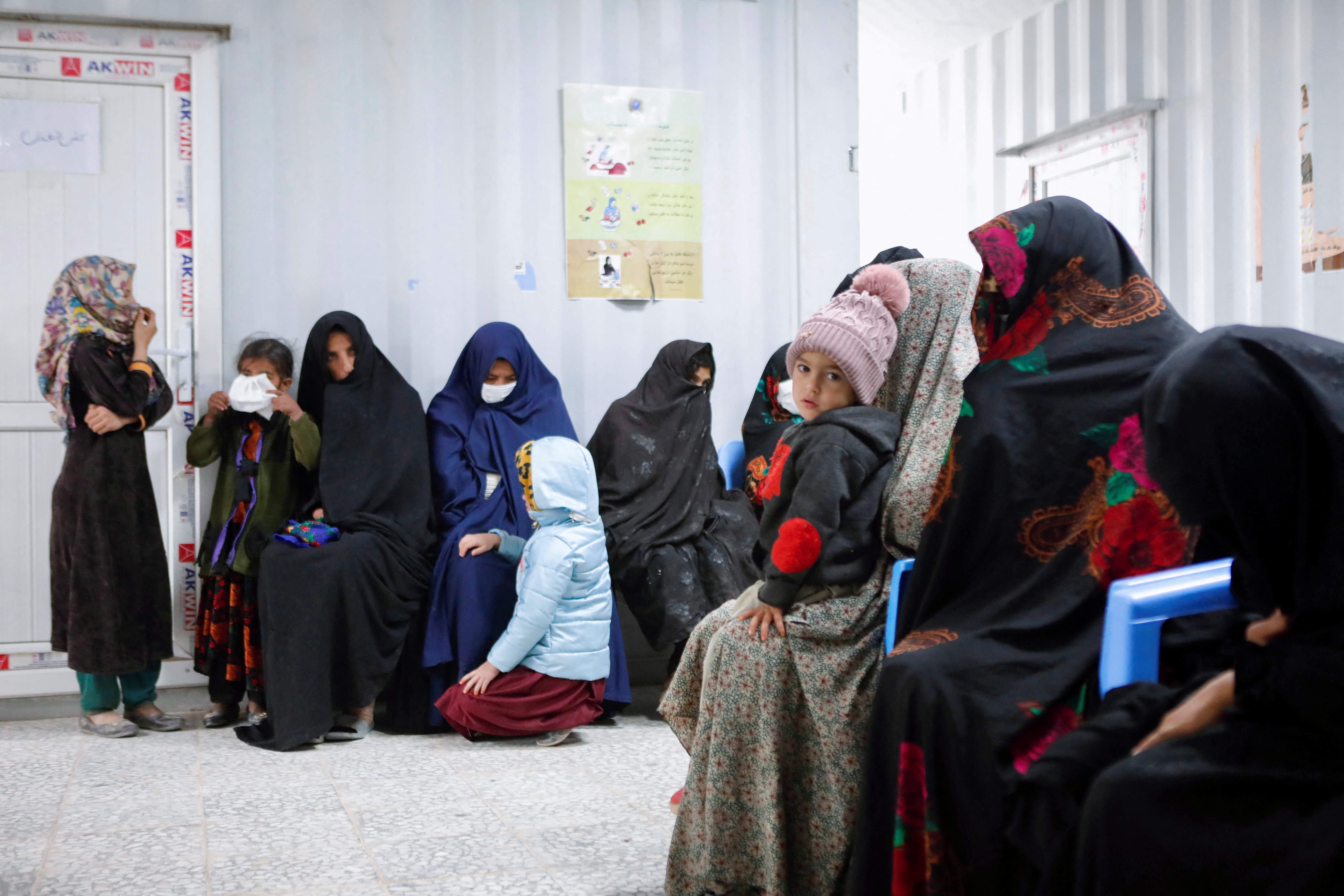 Afghan women and children wait for their turn to see a doctor at Yaka Dokan health clinic run by nonprofit organization