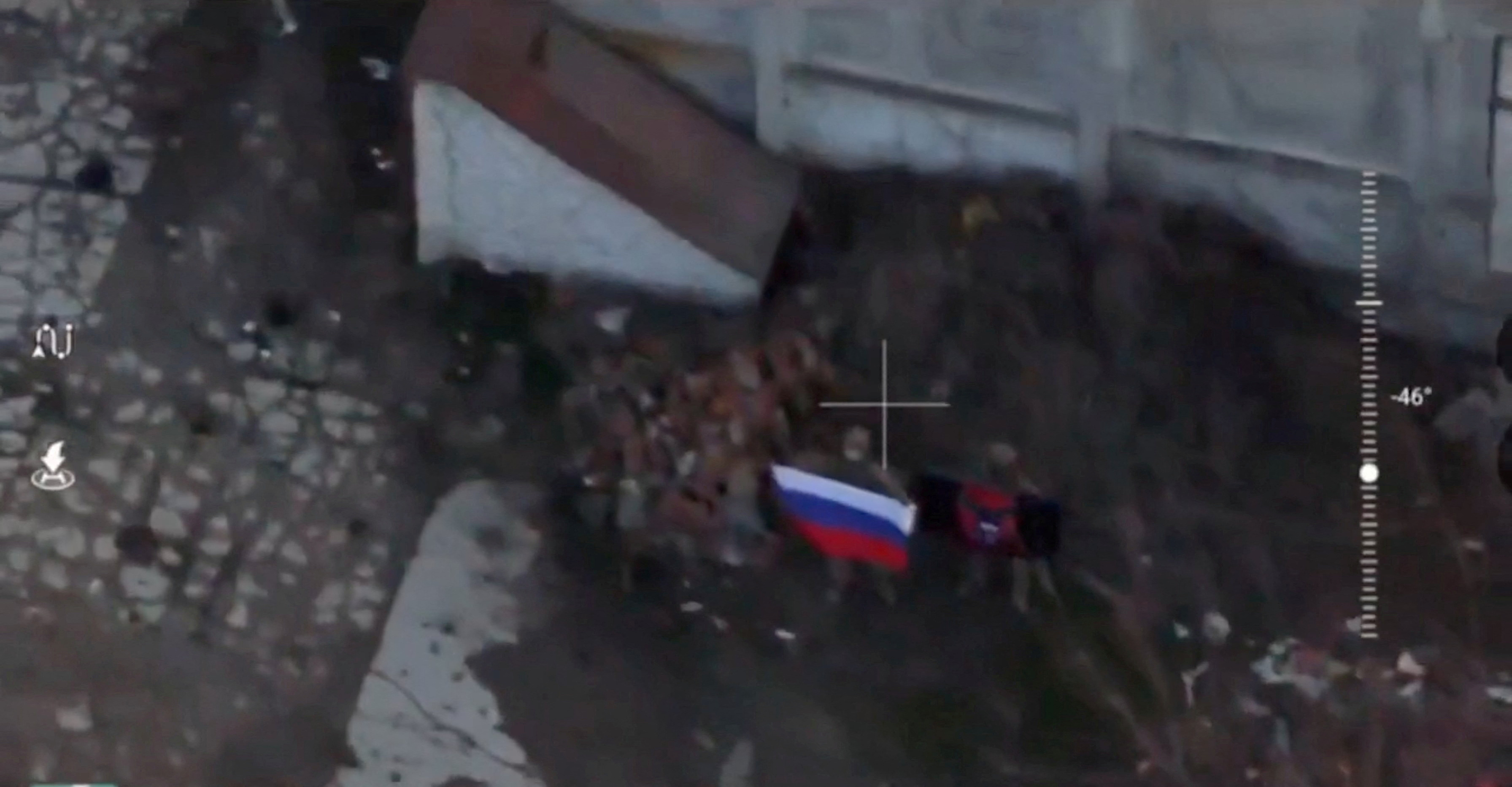 A soldier holds up a Russian flag in Kurakhove, Donetsk Region, Ukraine in this screen grab taken from a social media video released on January 5, 2025, obtained by Reuters. Social Media/via REUTERS THIS IMAGE HAS BEEN SUPPLIED BY A THIRD PARTY. NO RESALES. NO ARCHIVES. OVERLAY FROM SOURCE.