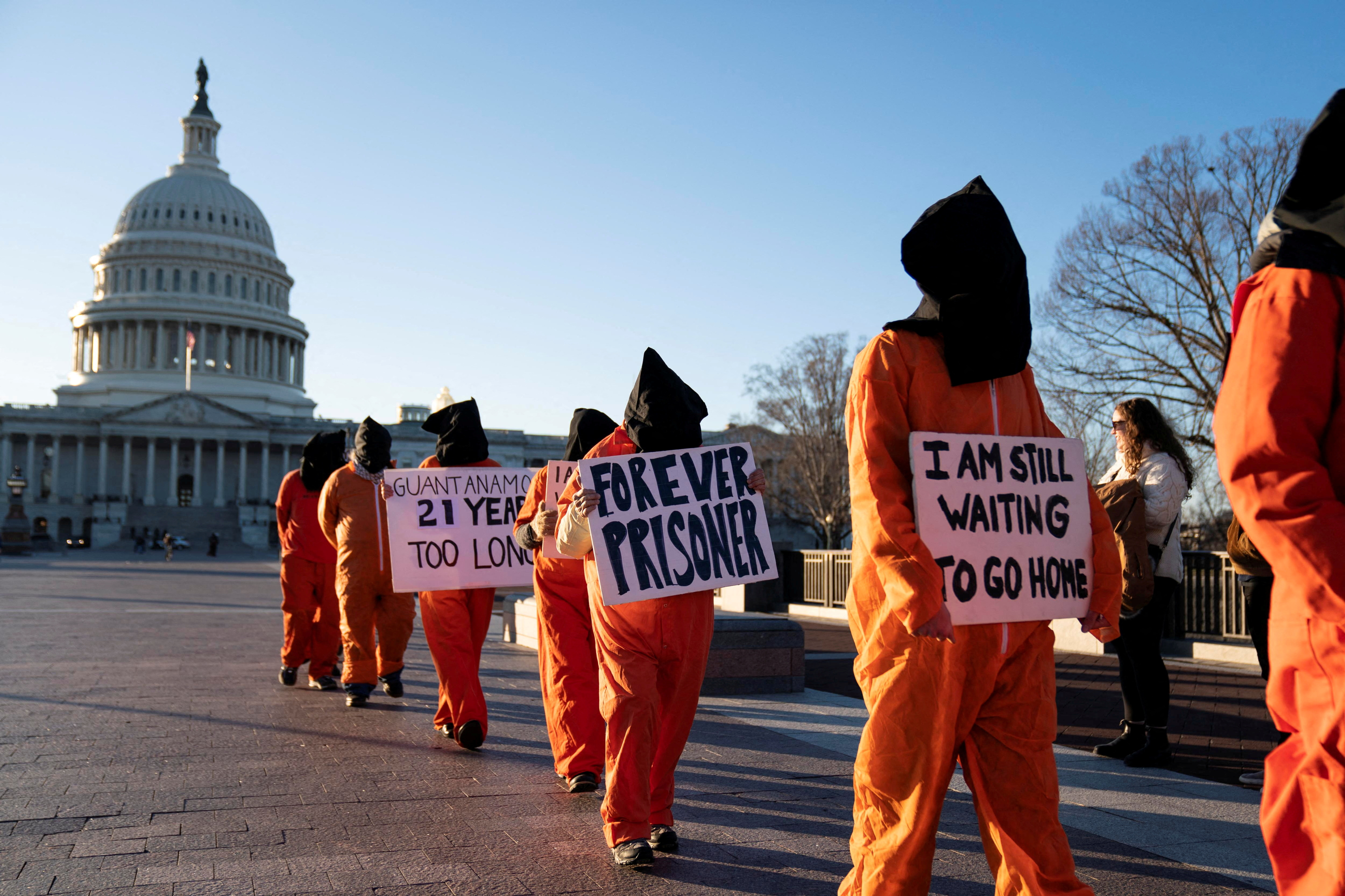 Demonstrators in orange jumpsuits protest Guantanamo outside US Capitol