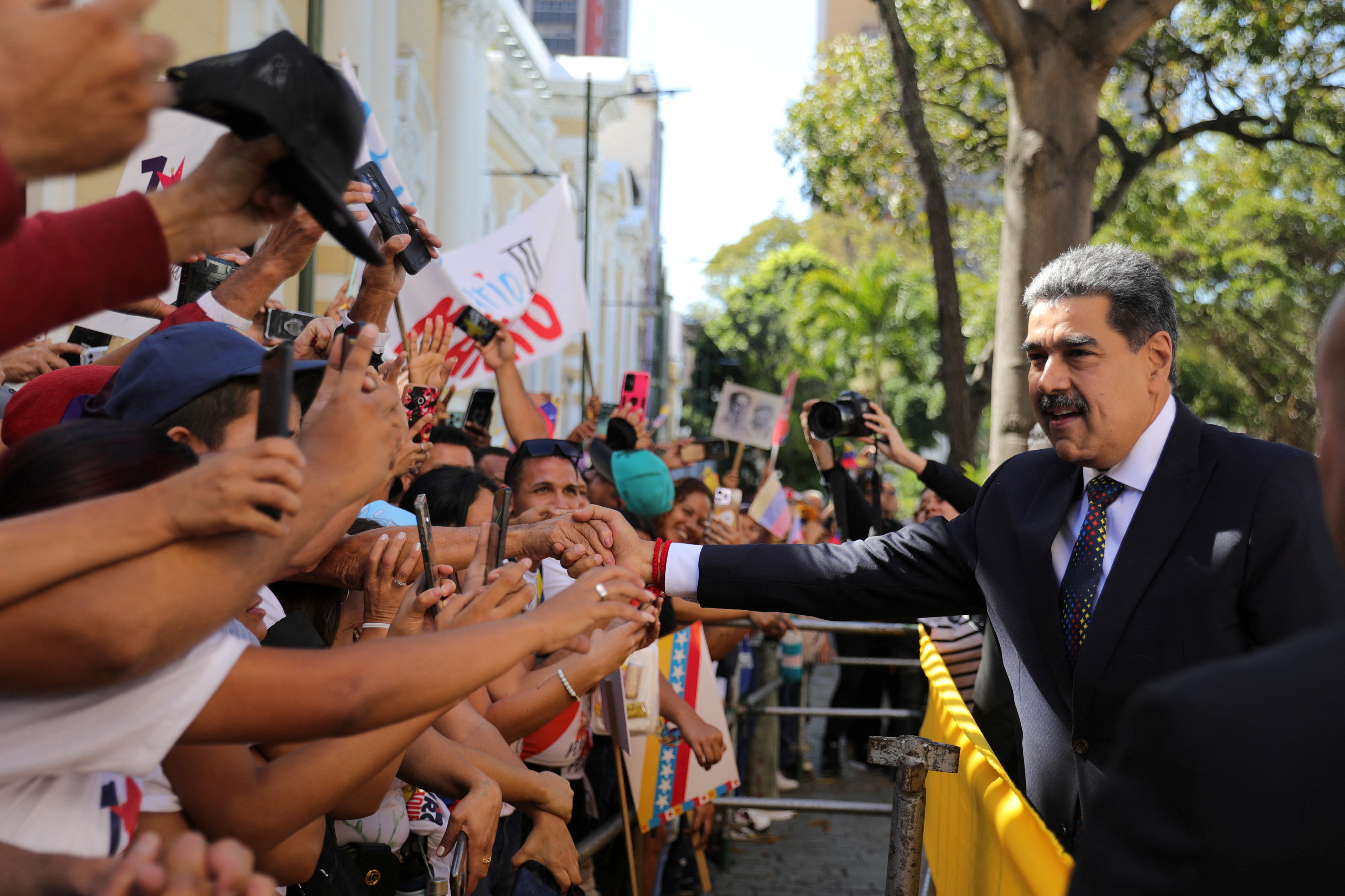 Nicolas Maduro greets supporters outside his inauguration.