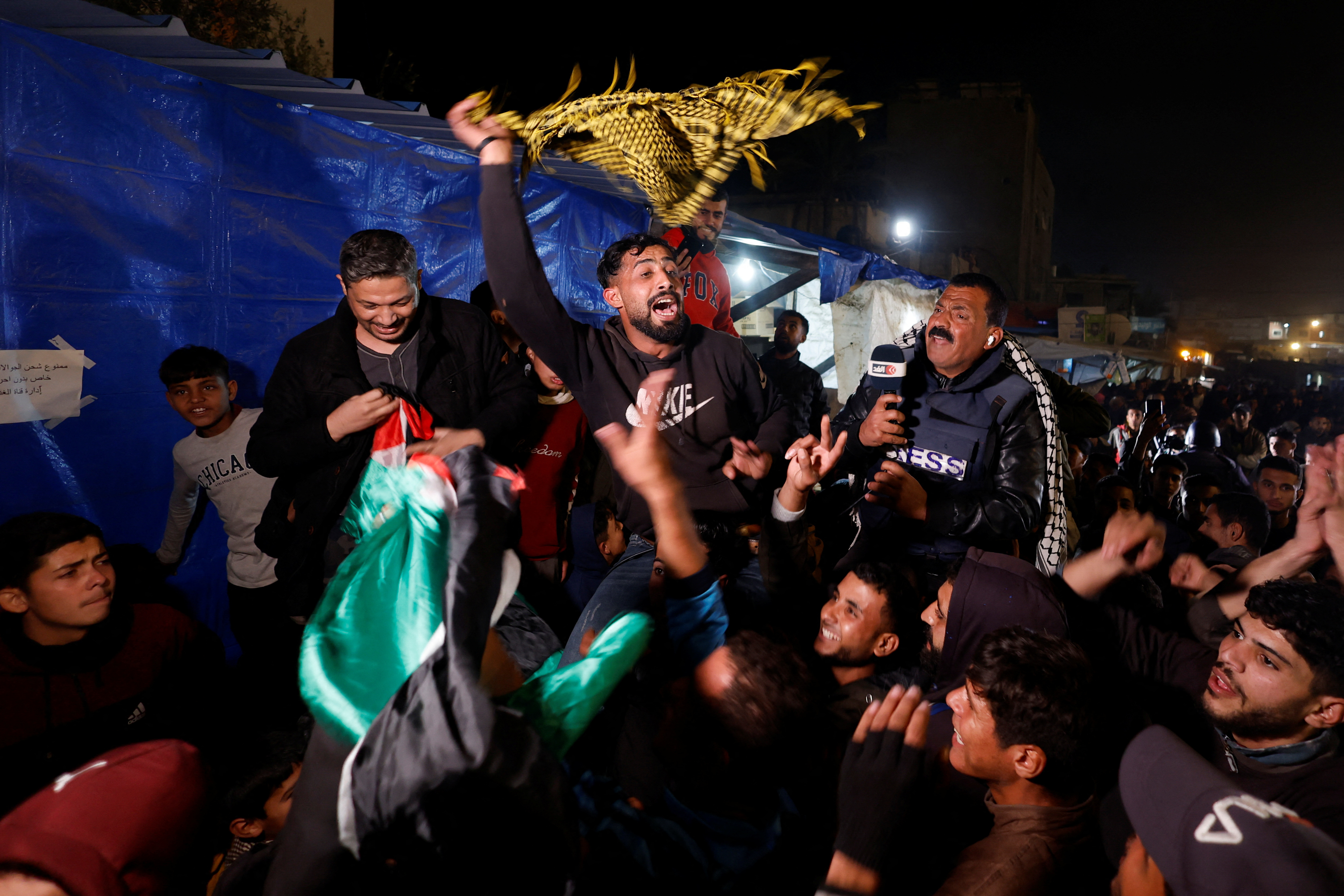 Palestinians react as they wait for news of a ceasefire deal with Israel