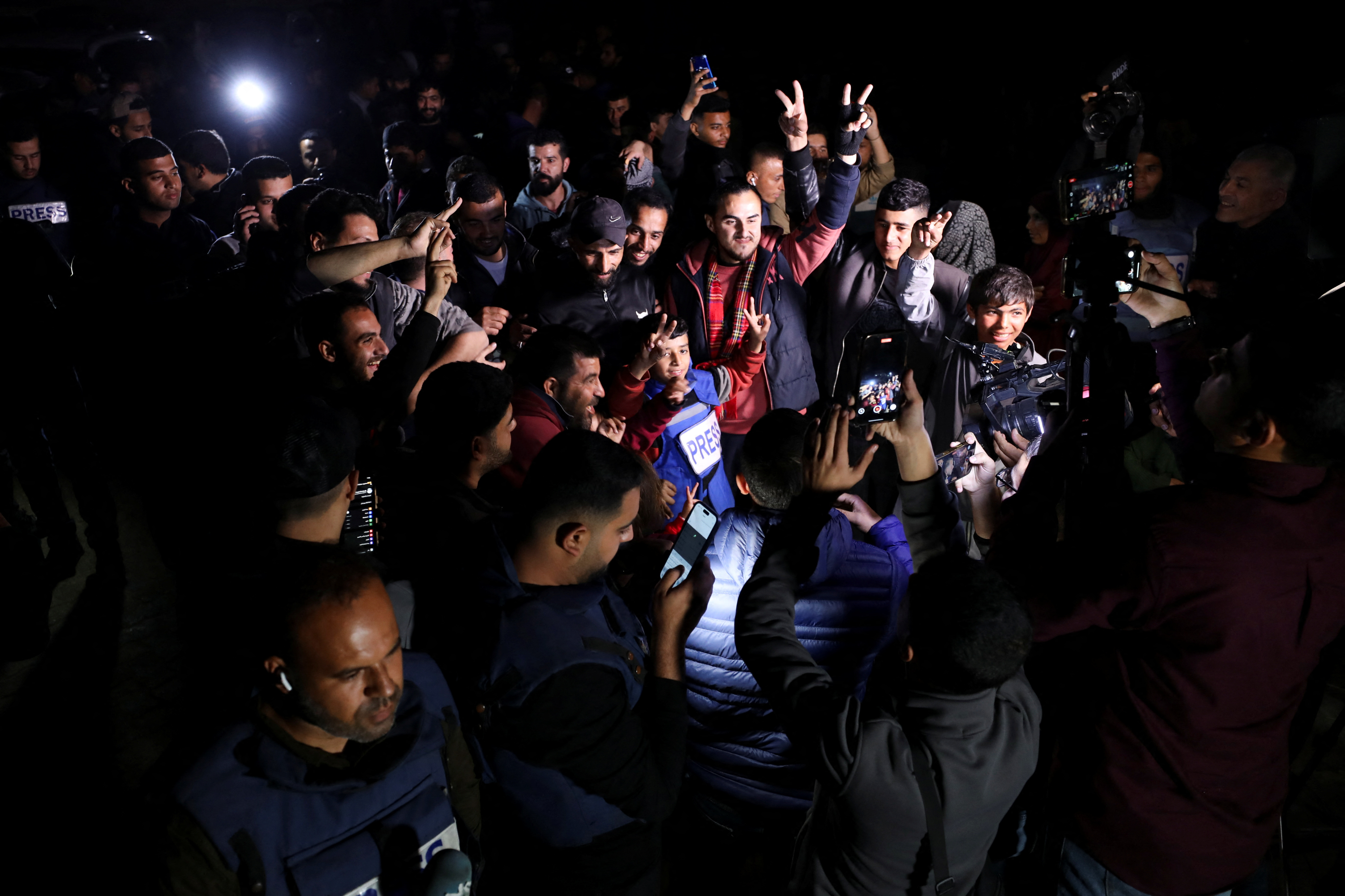 Palestinians react as they wait for news of a ceasefire deal with Israel