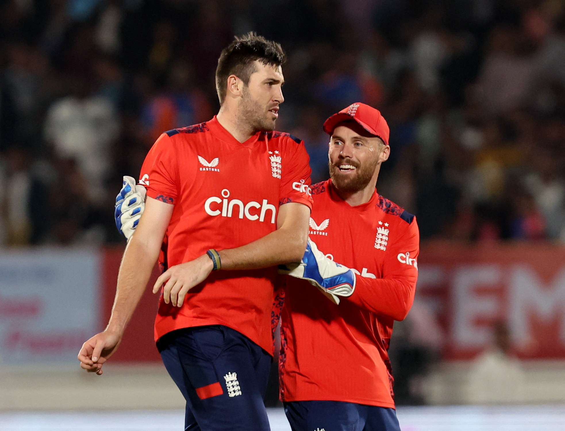 Cricket - Third T20 International - India v England - Saurashtra Cricket Association Stadium, Rajkot, India - January 28, 2025 England's Jamie Overton celebrates with Phil Salt after taking the wicket of India's Hardik Pandya, caught by Jos Buttler REUTERS/Amit Dave
