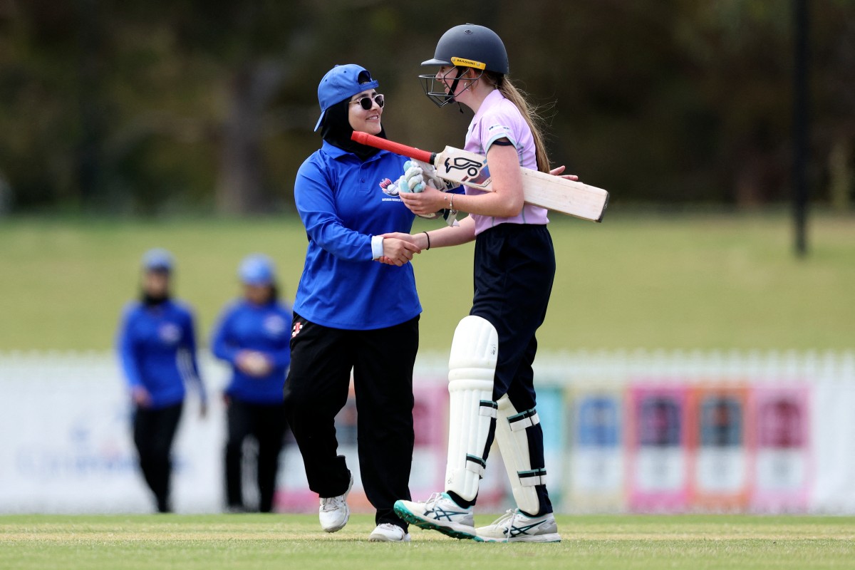 Players from both teams shake hands during the cricket match between Afghanistan Women's XI