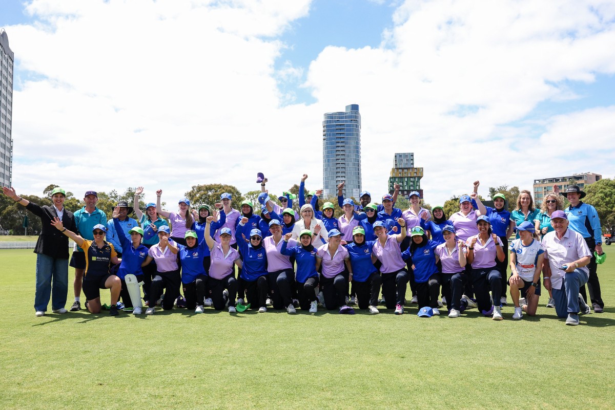 Players from both teams pose for a photo