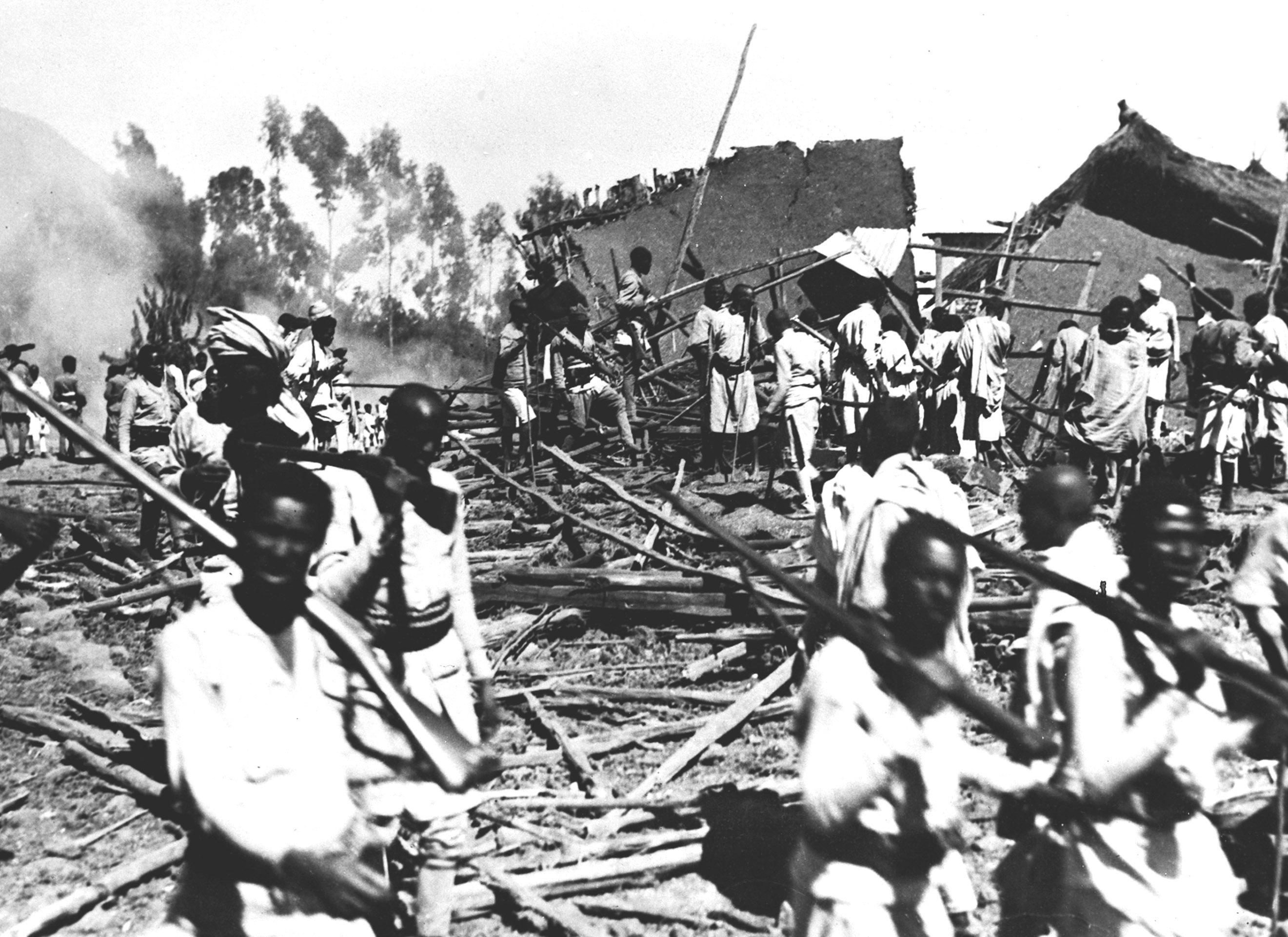 Abyssinians search the smouldering debris of wrecked homes following an Italian air raid, on December 6, 1935. In the most ferocious bombing raid of the Italian war on Abyssinia, a squadron of 18 bombers flew over Dessie and dropped explosive and incendiary bombs. Some 300 bombs were dropped in one day, killing more than 40 and injuring 325. Among the buildings hit were the Red Cross and the Emperor’s Palace