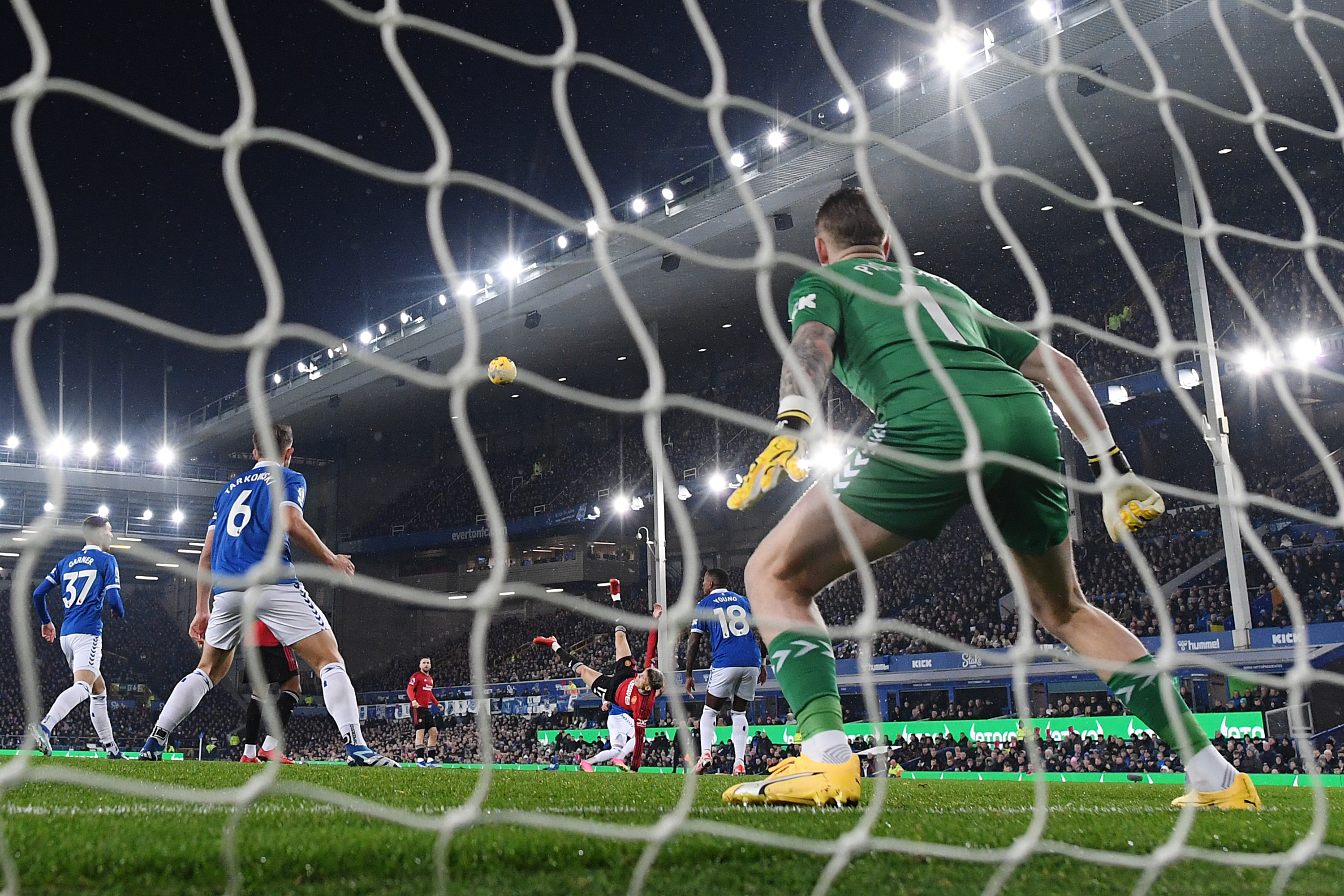 LIVERPOOL, ENGLAND - NOVEMBER 26: (EDITORS NOTE: In this photo taken from a remote camera from behind the goal.) Jordan Pickford of Everton fails to save as Alejandro Garnacho of Manchester United scores the team's first goal during the Premier League match between Everton FC and Manchester United at Goodison Park on November 26, 2023 in Liverpool, England. (Photo by Shaun Botterill/Getty Images)