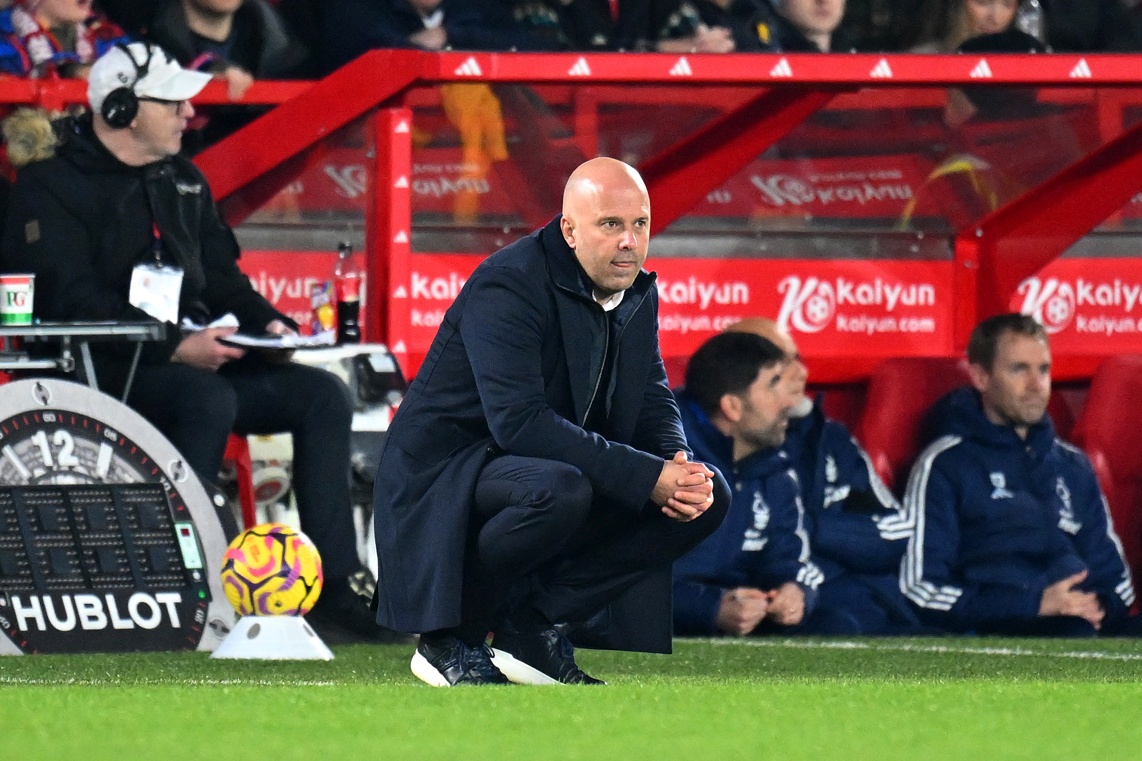 NOTTINGHAM, ENGLAND - JANUARY 14: Arne Slot, Manager of Liverpool, crouches as he looks on from the touchline during the Premier League match between Nottingham Forest FC and Liverpool FC at City Ground on January 14, 2025 in Nottingham, England. (Photo by Michael Regan/Getty Images)
