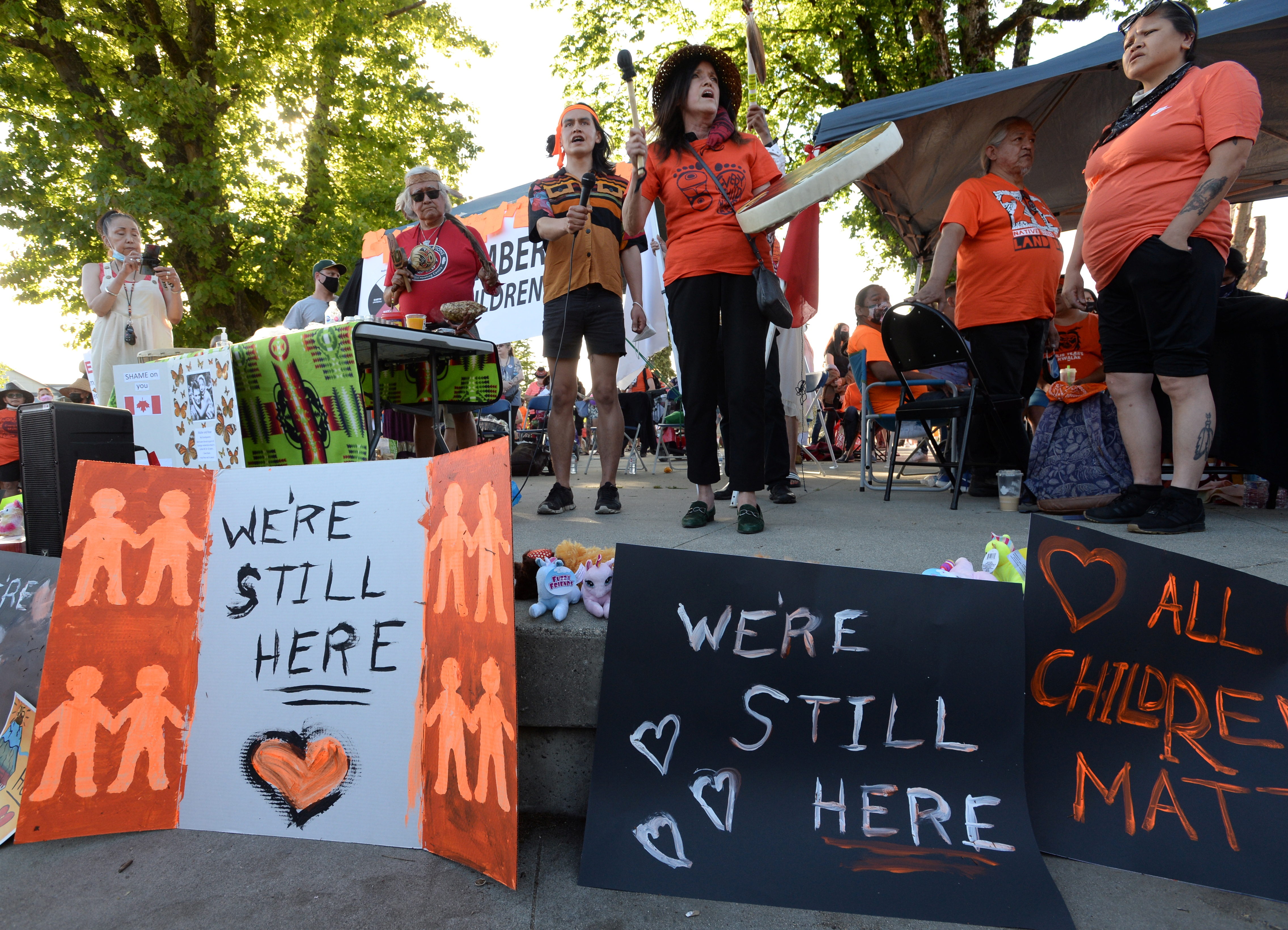 People sing at a rally to honour residential school survivors in Canada