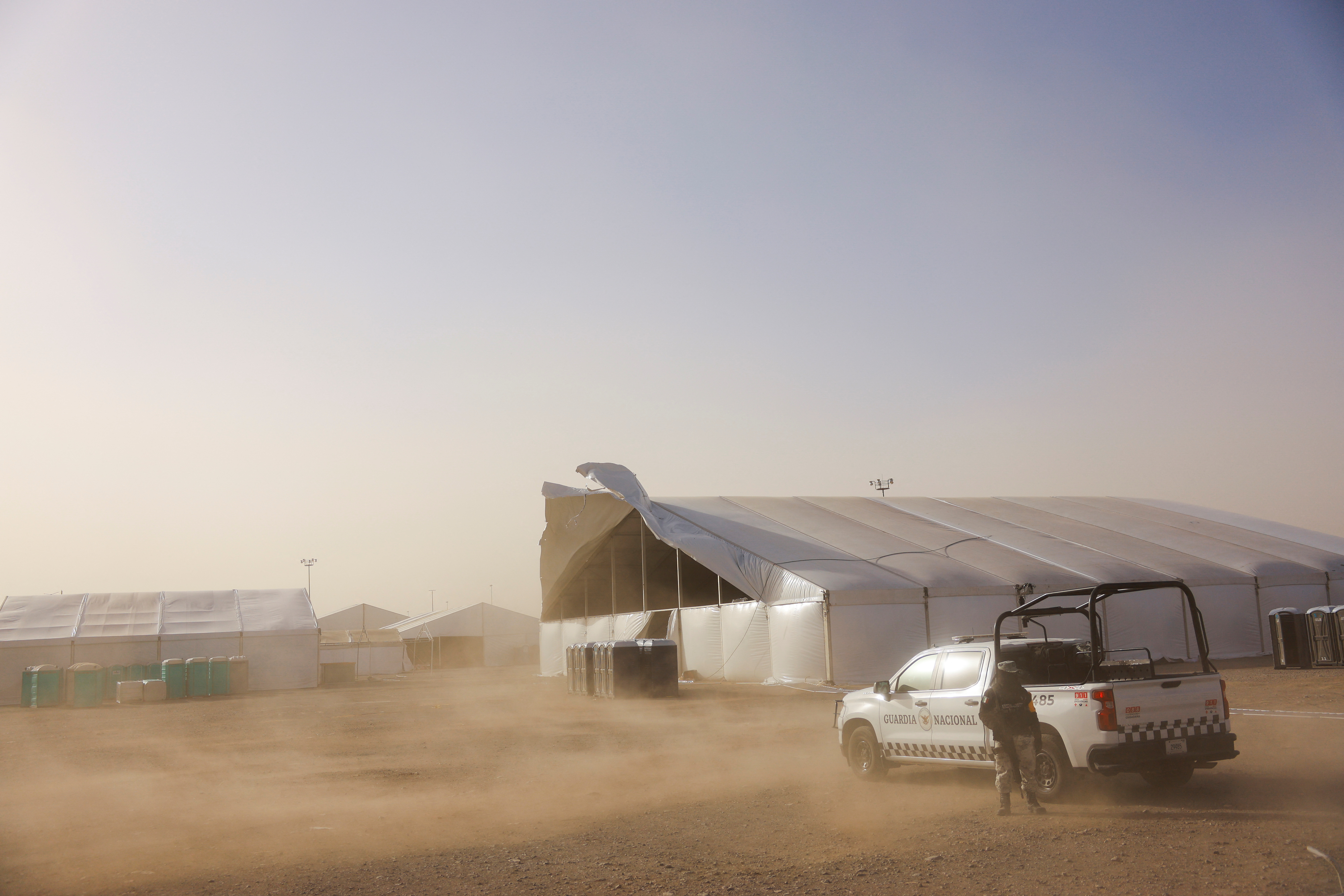 A giant tent is damaged during a sandstorm at the site where Mexican authorities are building a temporary shelter for migrants deported from the United States, in Ciudad Juarez, Mexico, January 30, 2025. REUTERS/Jose Luis Gonzalez