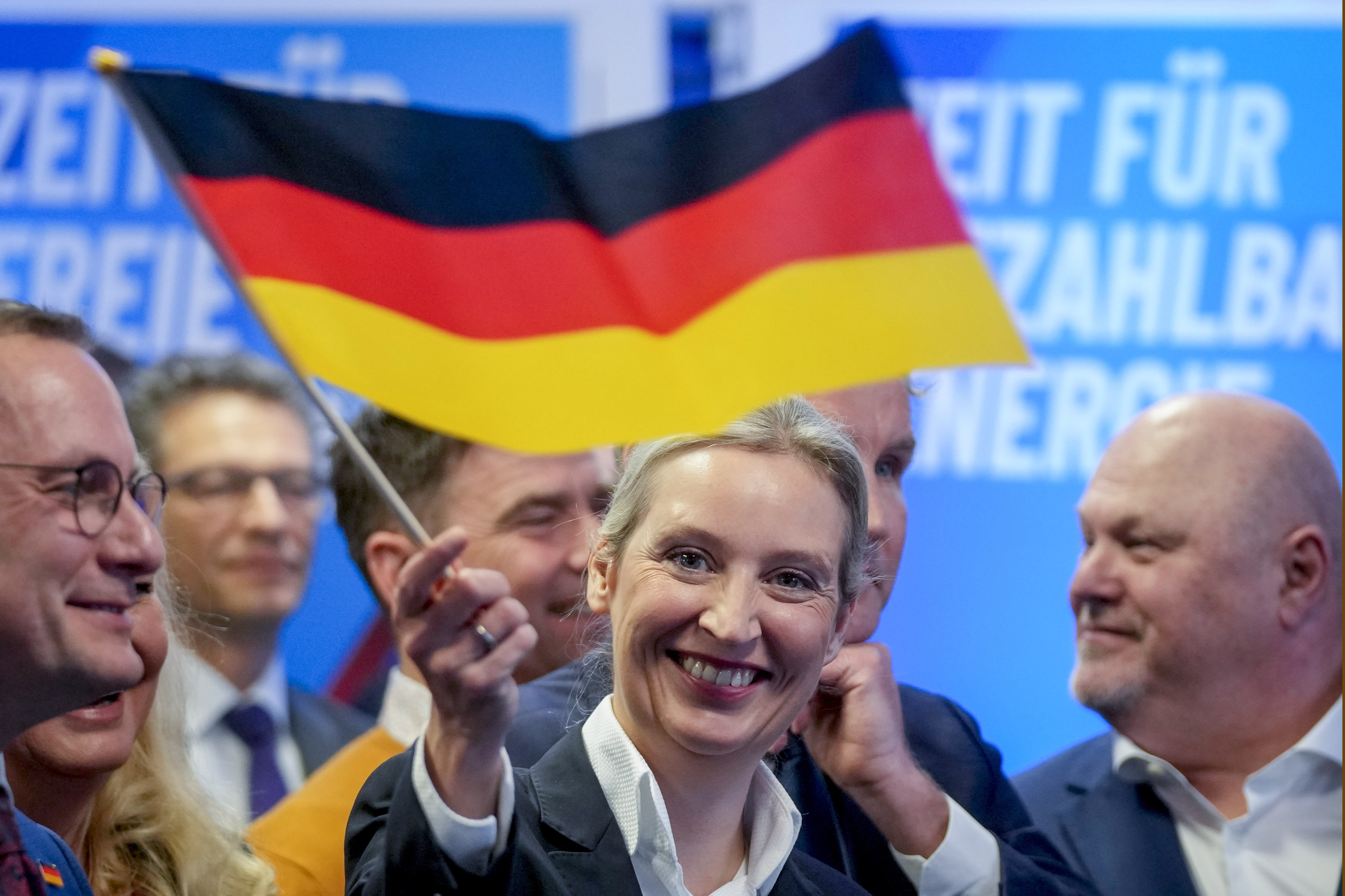 Leader of far right AfD Alice Weidel waves a German flag at the AfD party headquarters in Berlin, Germany, Sunday, Feb. 23, 2025